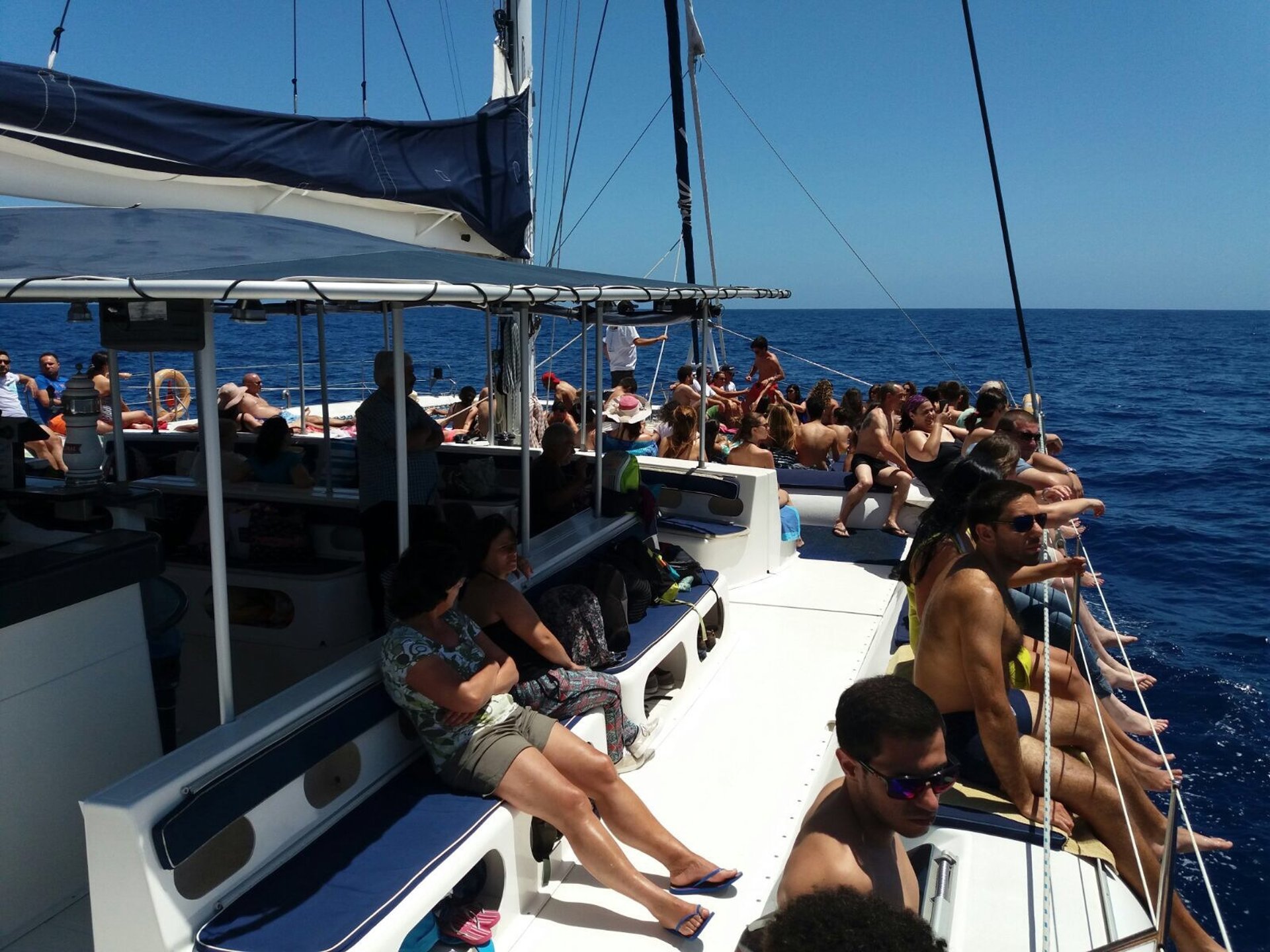 Tourists on Sea Born catamaran deck at Cabo Girão.