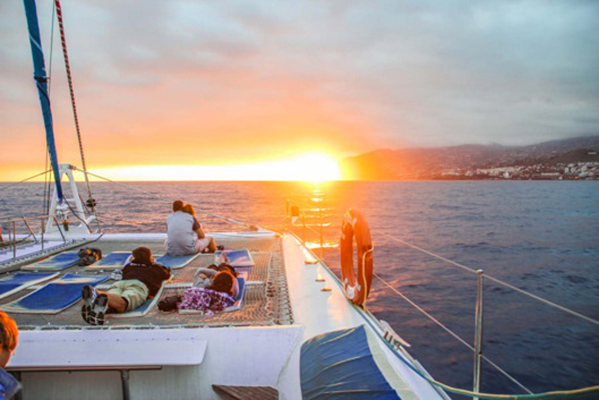 Passengers watching the sunset on Sea Born catamaran off the coast of Madeira.