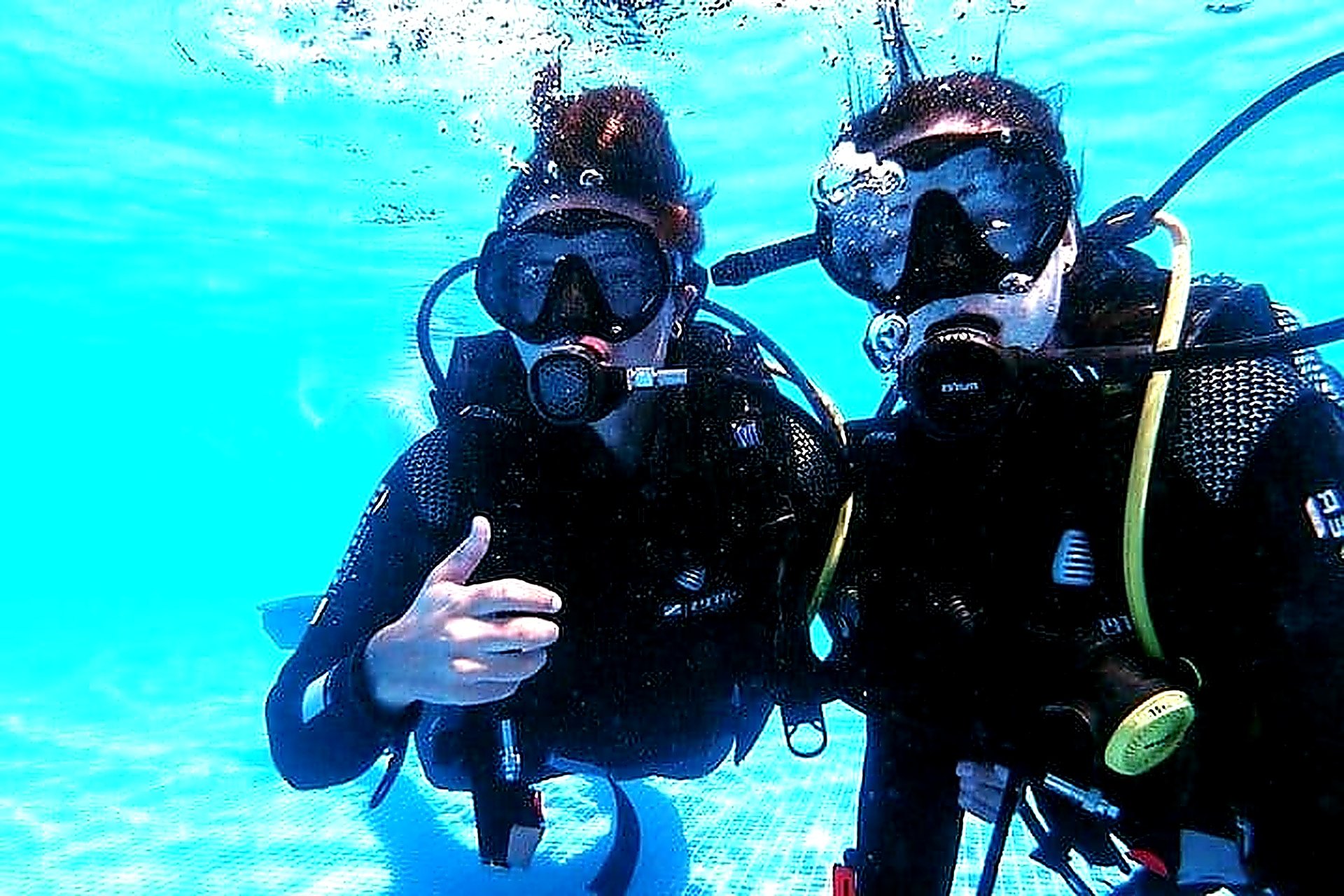 Two divers underwater during a try scuba diving taster experience at Quinta da Penha de França Mar, Madeira