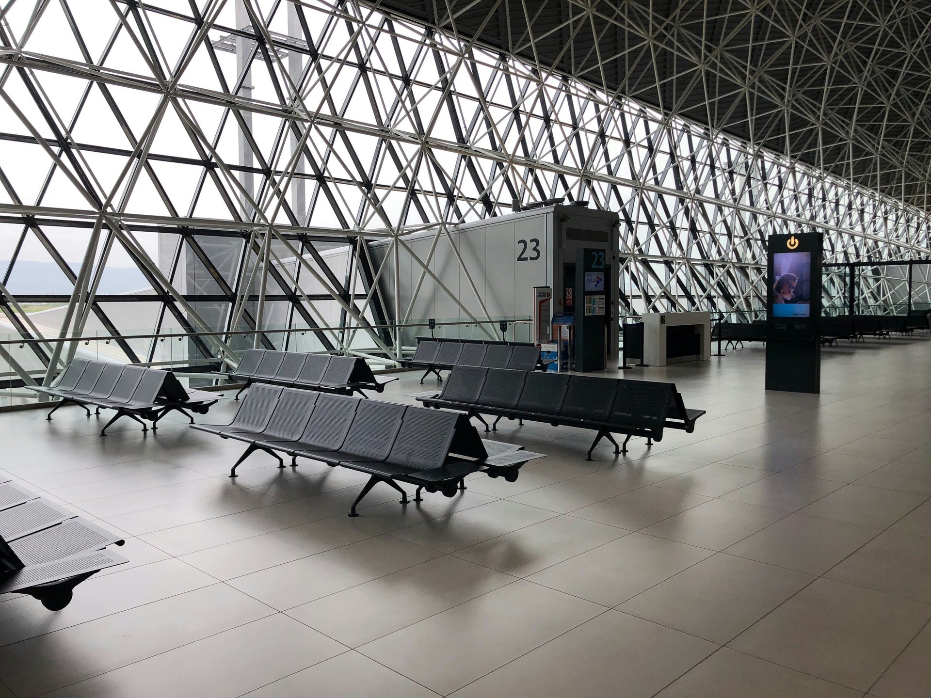 a man standing in front of a sign in an airport