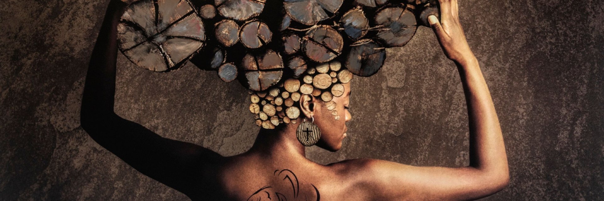 Fine art photography portrait of woman with log headdress symbolising nature, beauty, and strength.