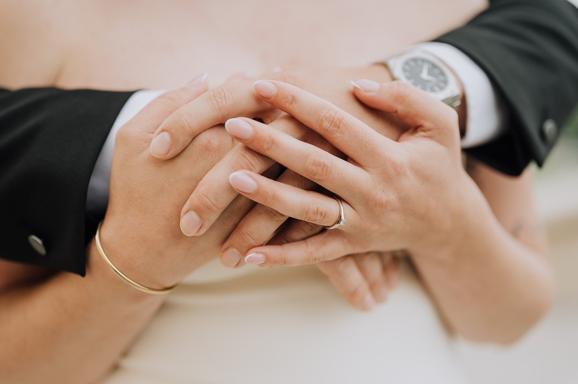 couple wearing silver-colored rings