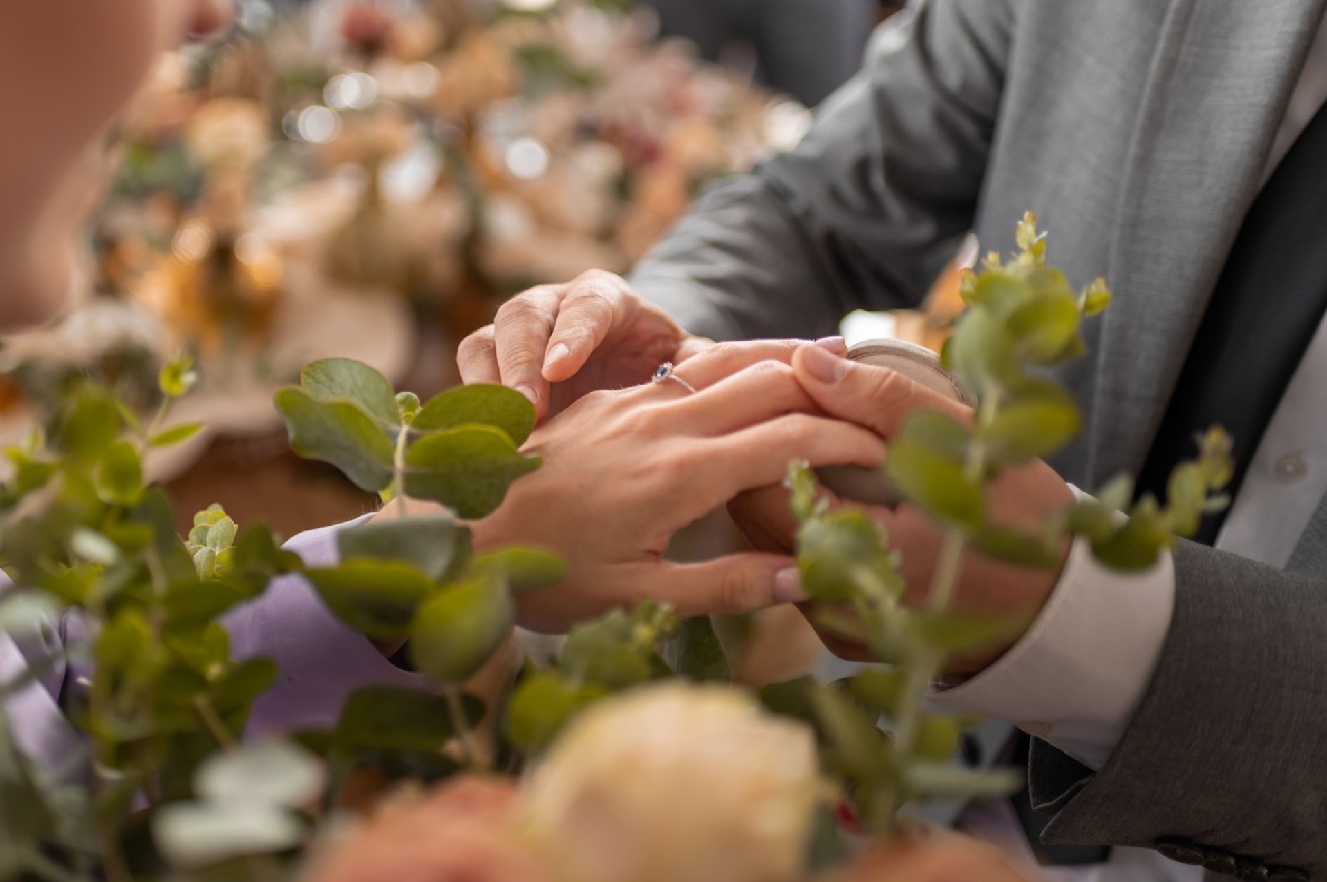 a woman in a wedding dress standing on a rock near the ocean