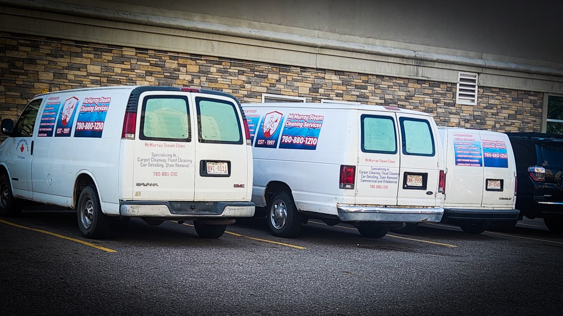 A person in protective suit cleans a carpet.