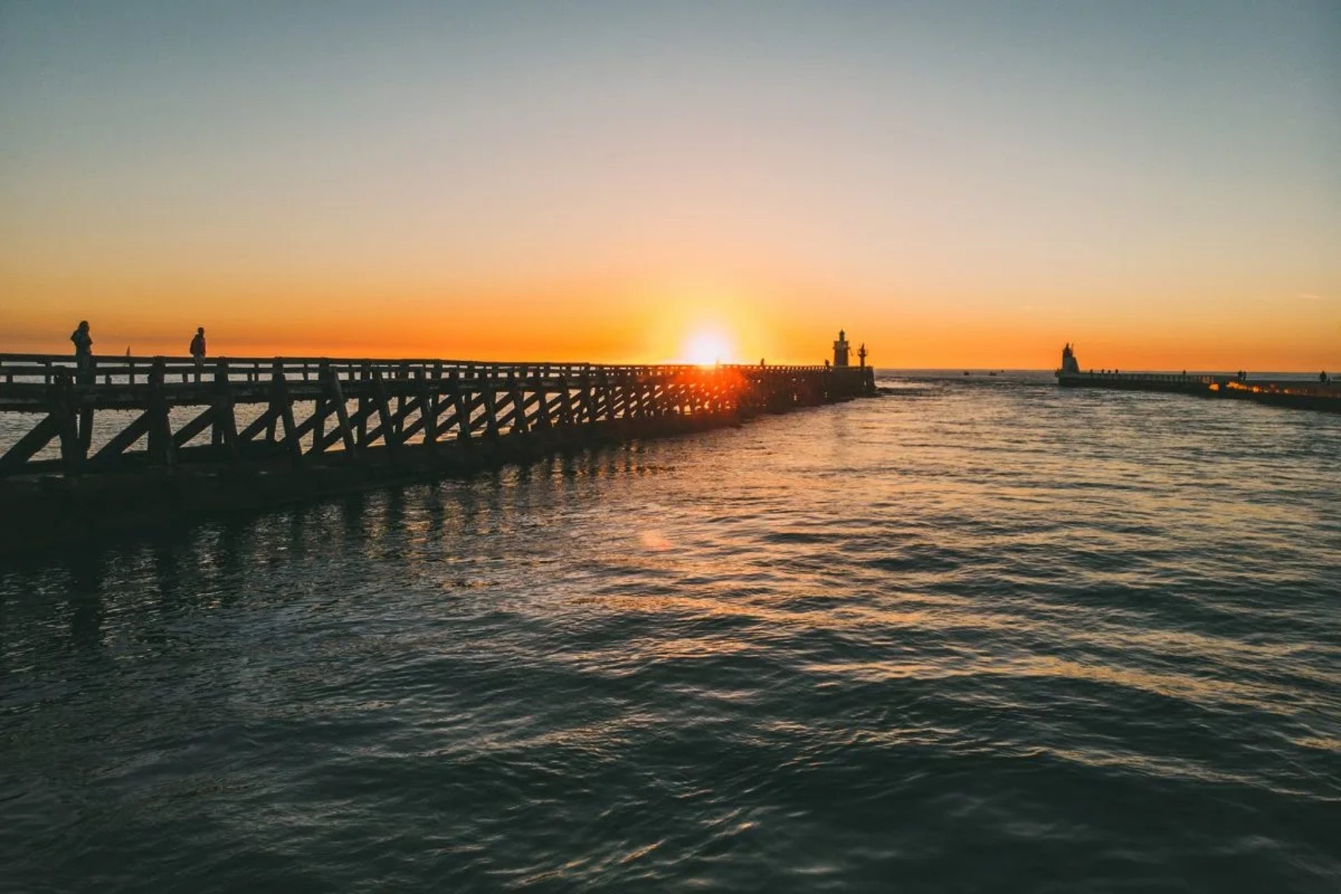 people walking on sidewalk near building during daytime
