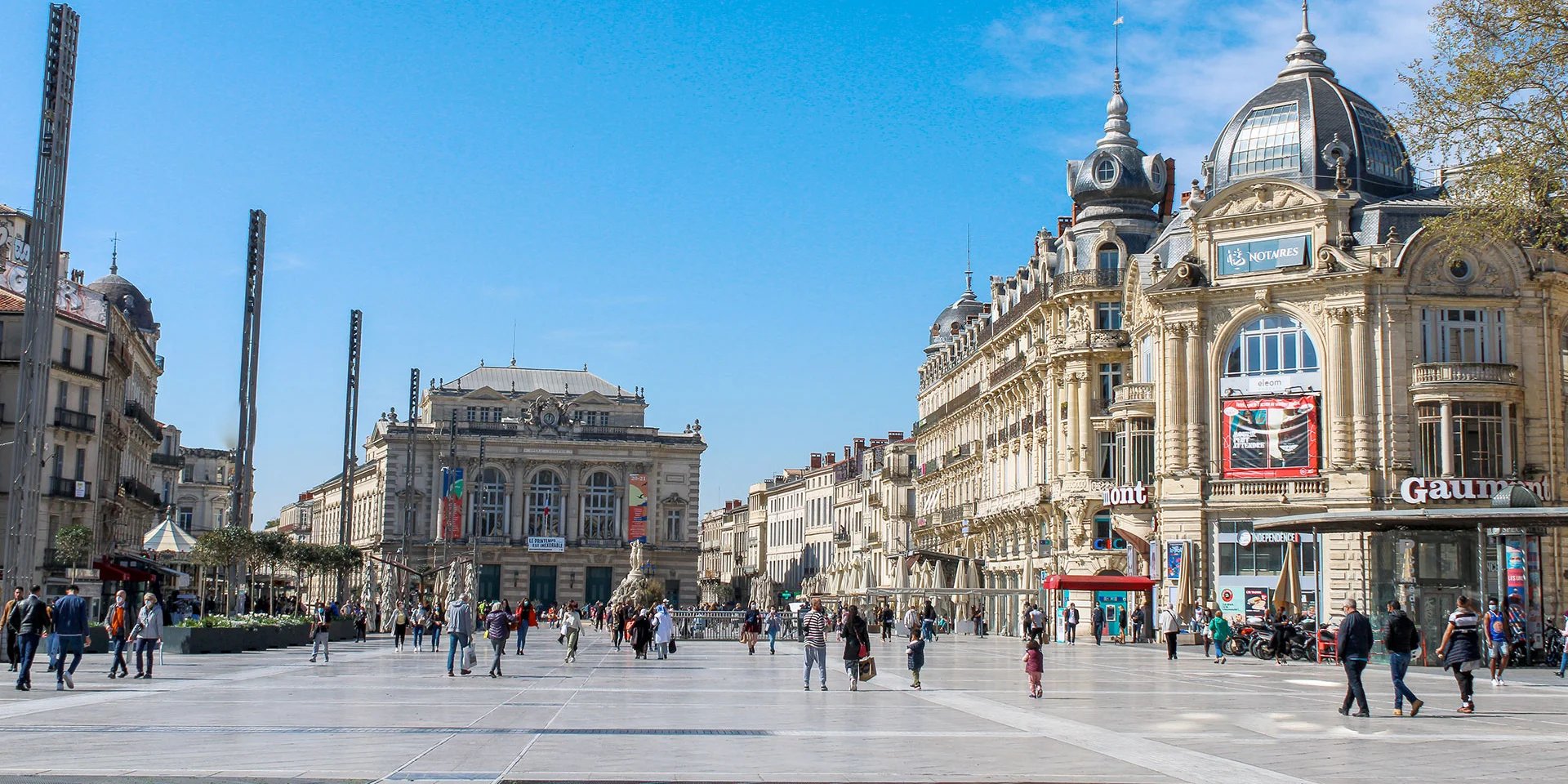 people walking on sidewalk near building during daytime