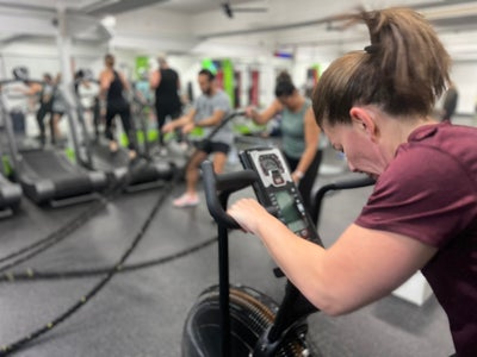 woman on stationary bike at 6X Training