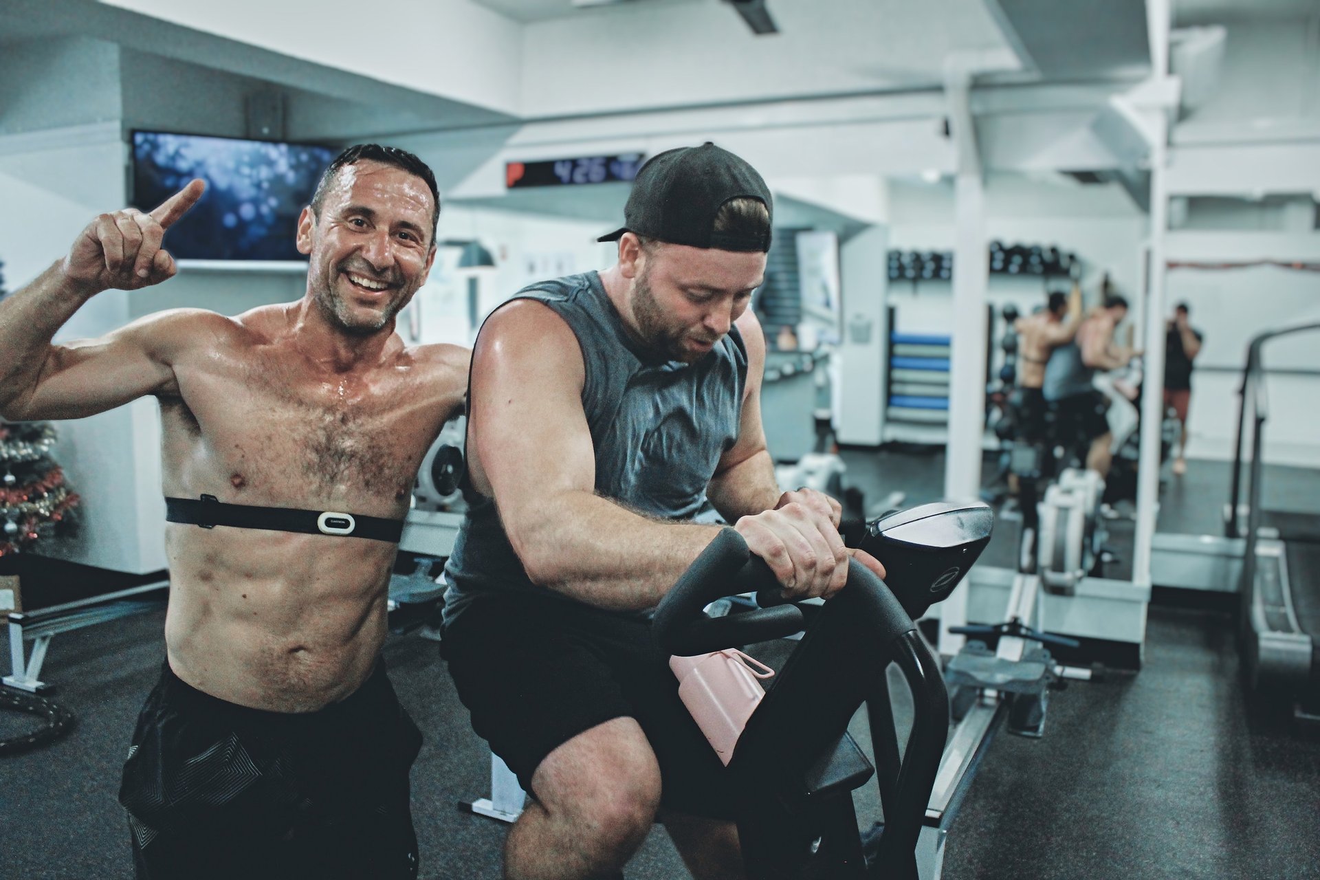 men happy in gym on stationary bike