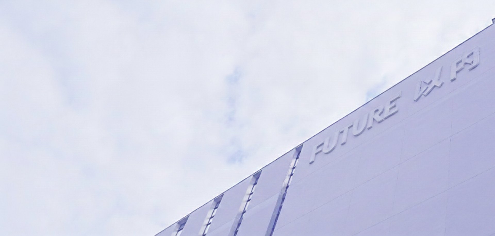 an abstract photo of a curved building with a blue sky in the background