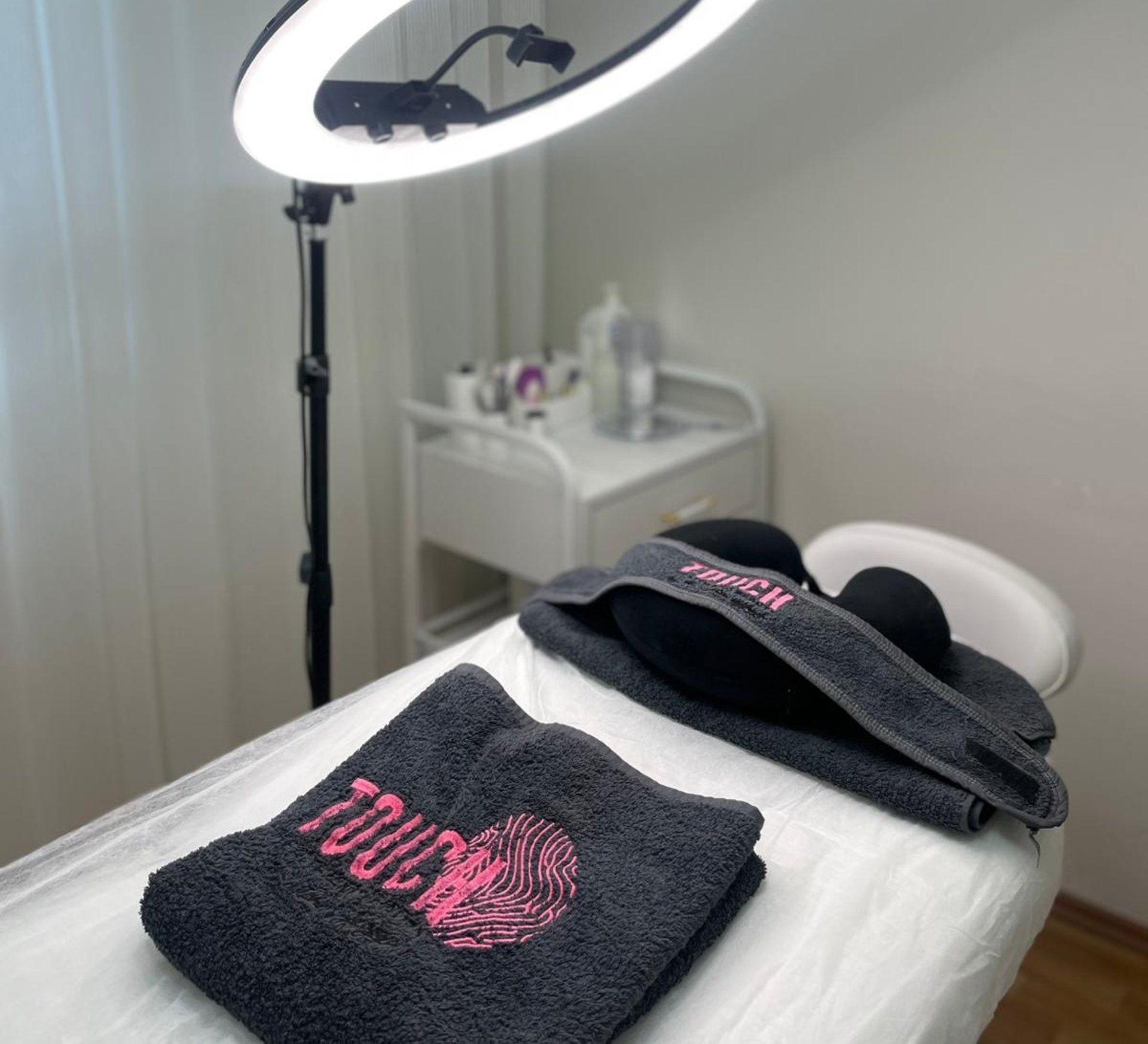 photo of assorted makeup products on gray surface