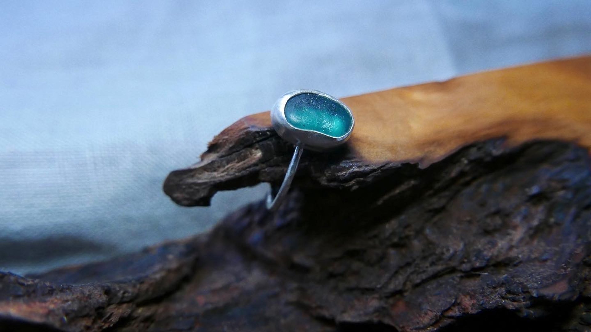 a group of green and blue glass beads