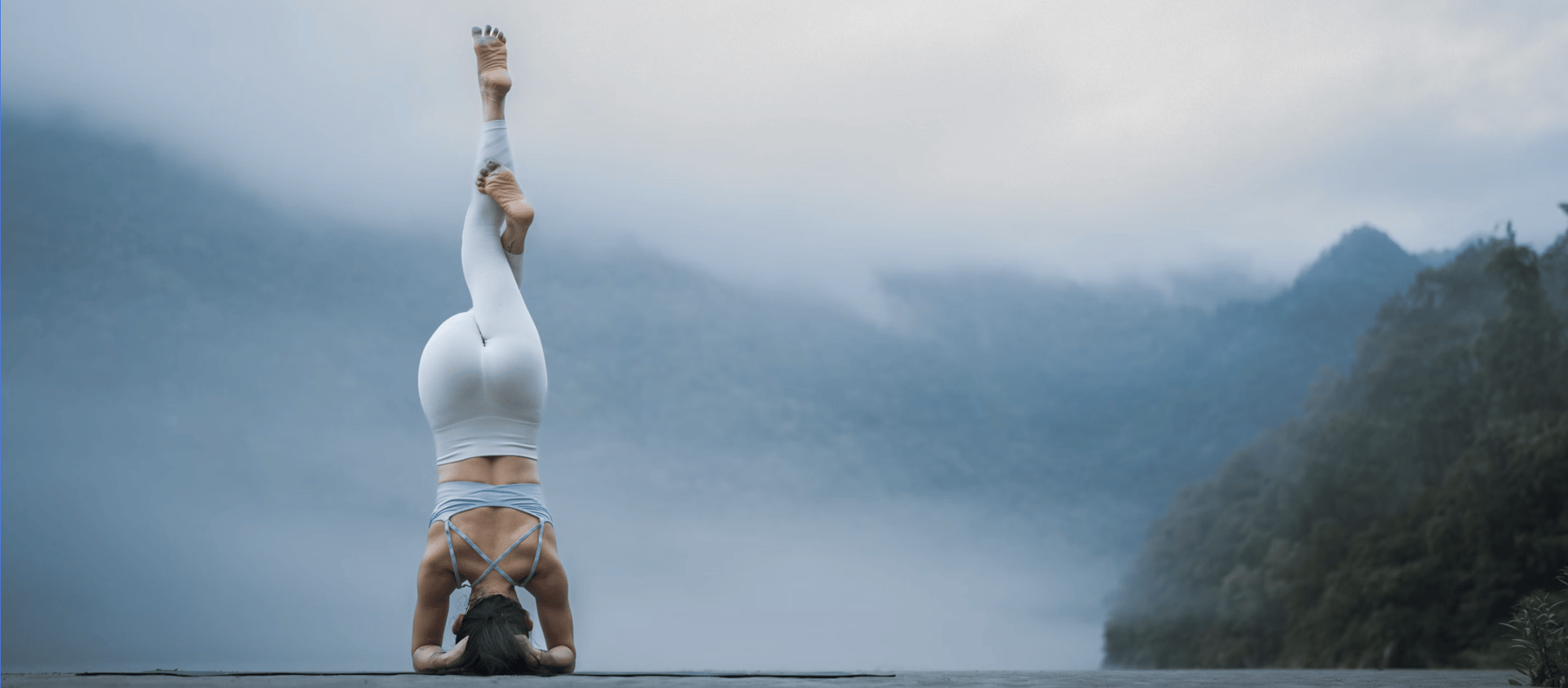 A person doing a handstand on a road