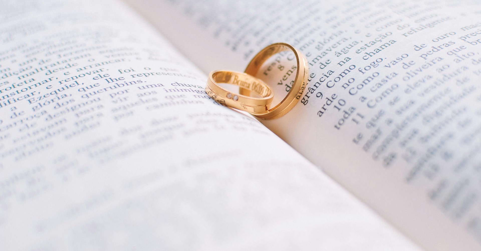 gold wedding band on white textile
