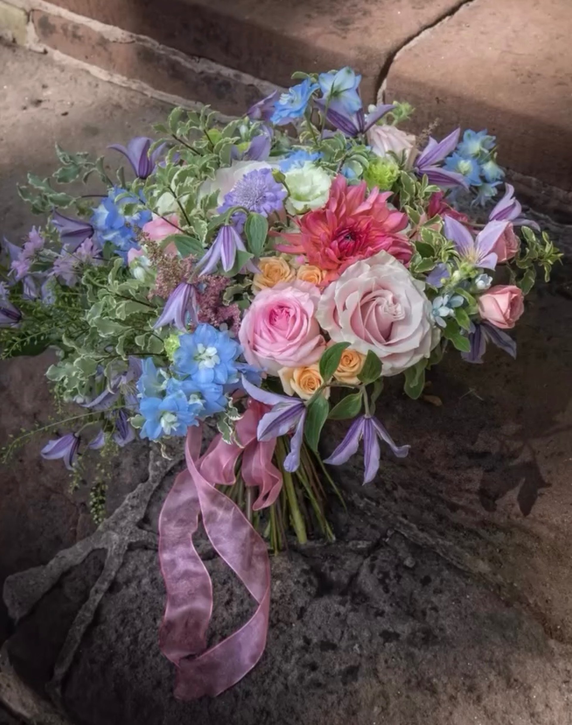 an abstract photo of a curved building with a blue sky in the background