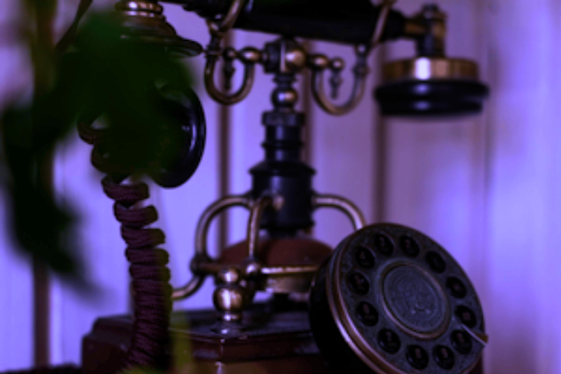 an old - fashioned phone with a cord attached to it