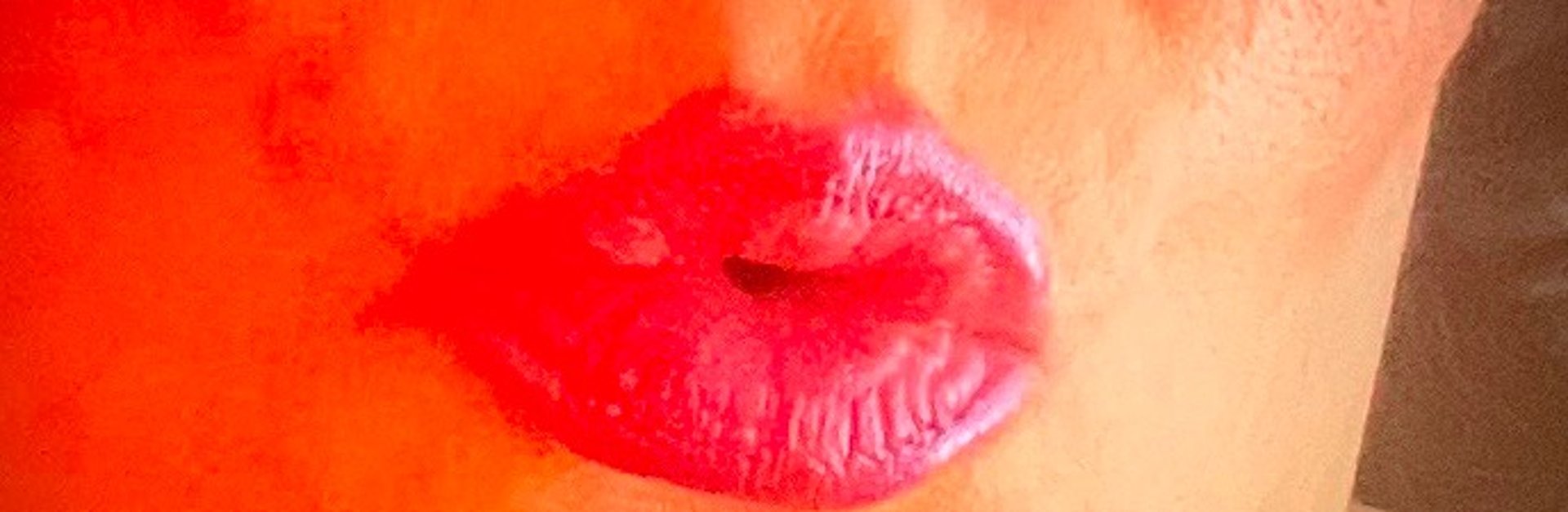 an abstract photo of a curved building with a blue sky in the background