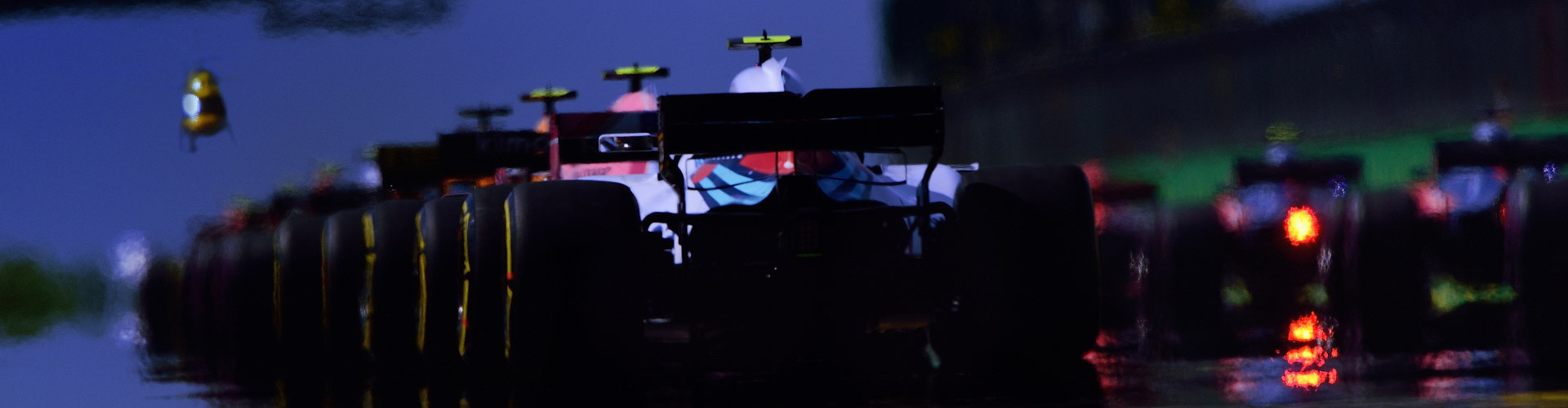 A race car is driving on the track.