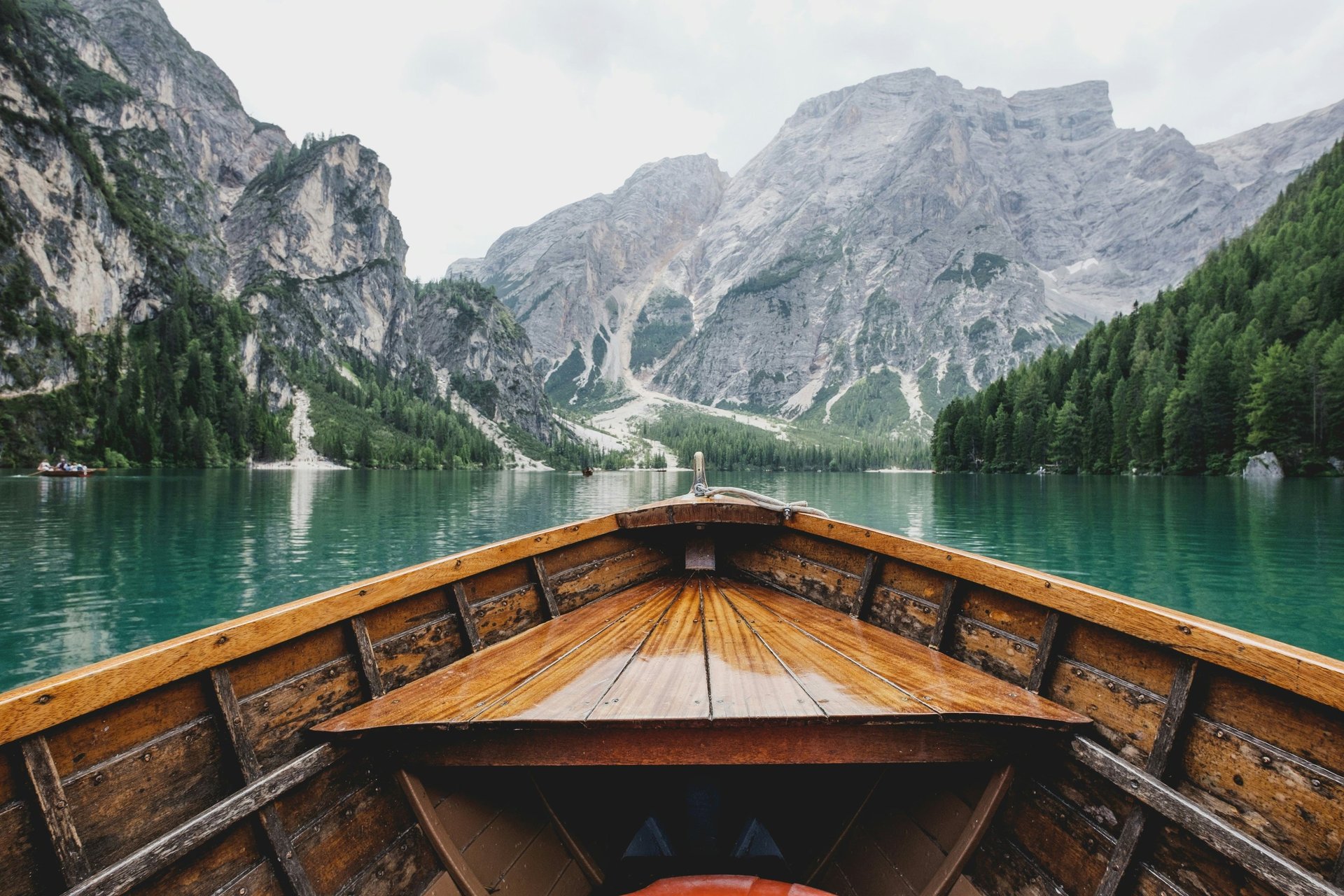 three brown wooden boat on blue lake water taken at daytime
