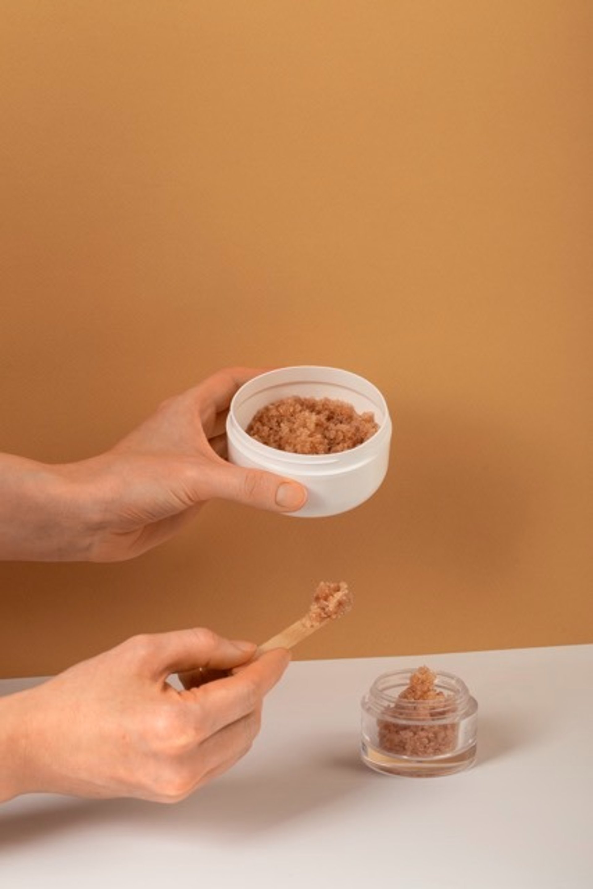 a woman's hand holding a bottle of lotion