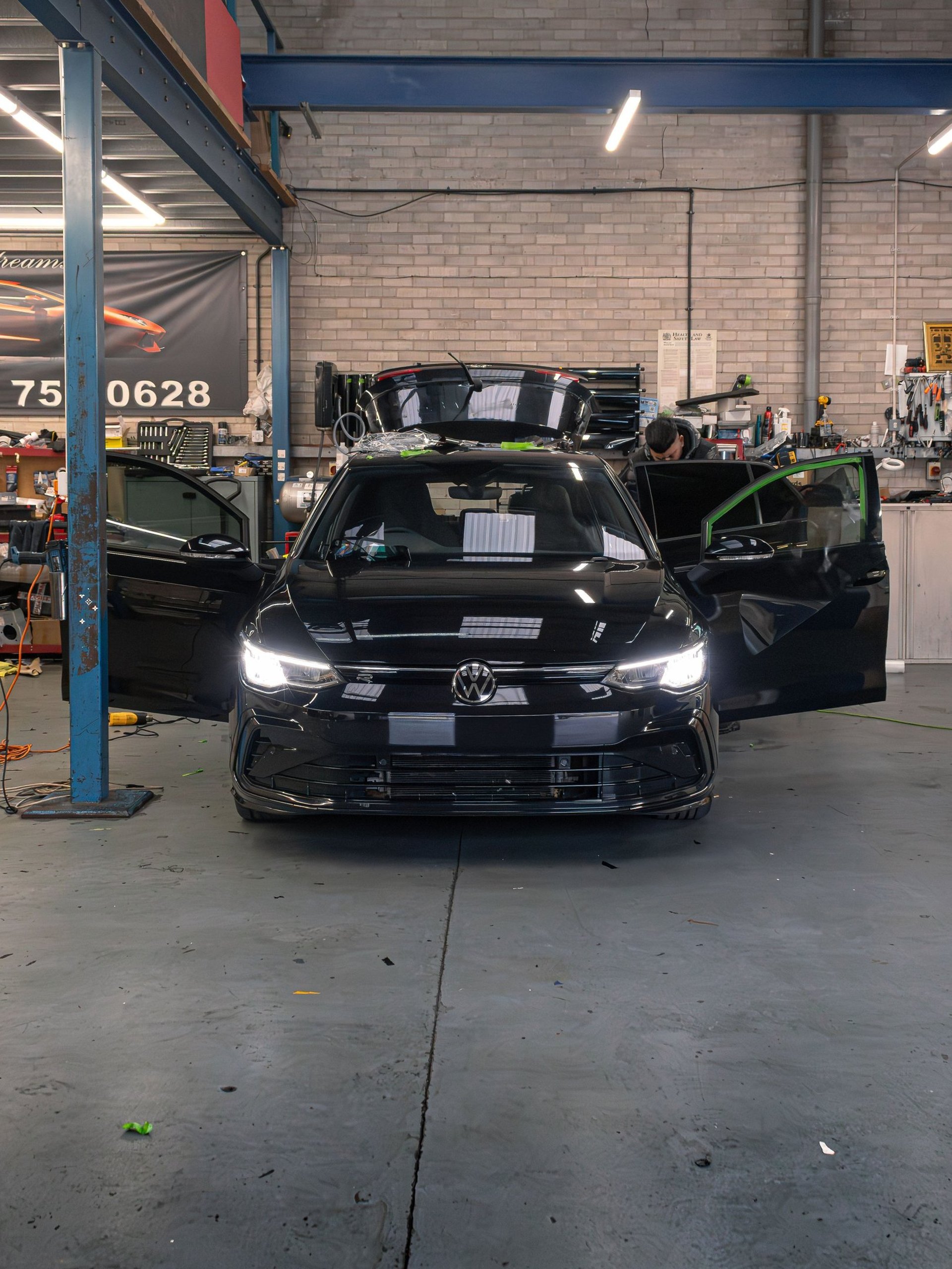 a blue sports car parked on the side of the road