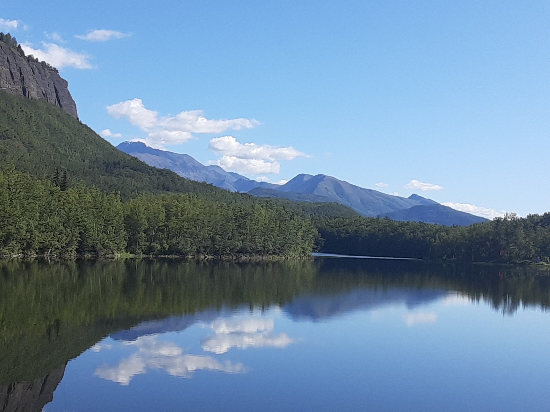 woman wearing yellow long-sleeved dress under white clouds and blue sky during daytime