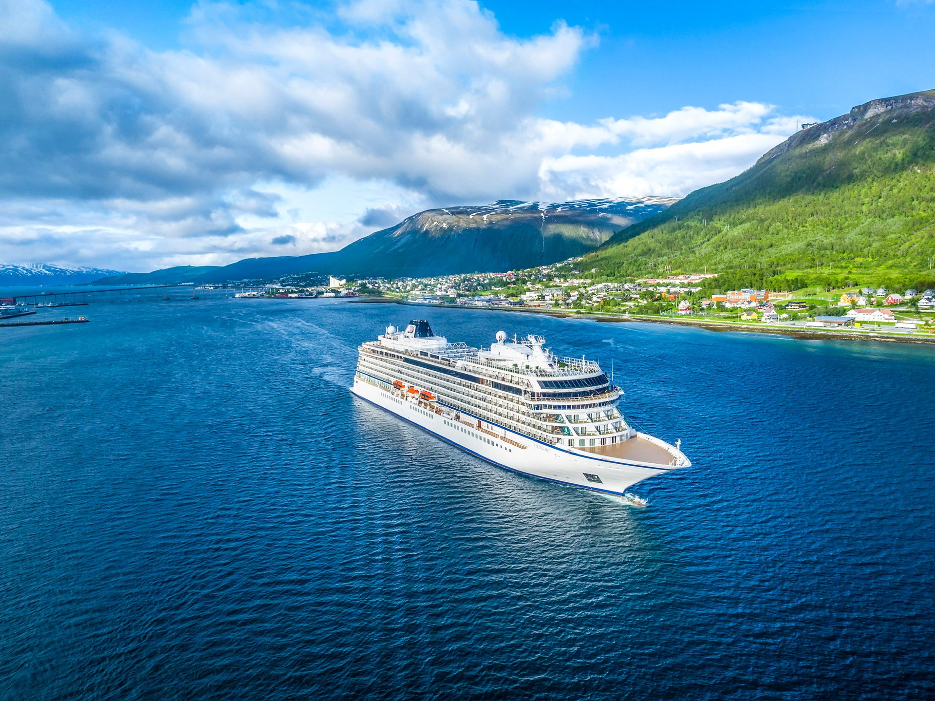 white cruise ship under cloudy sky