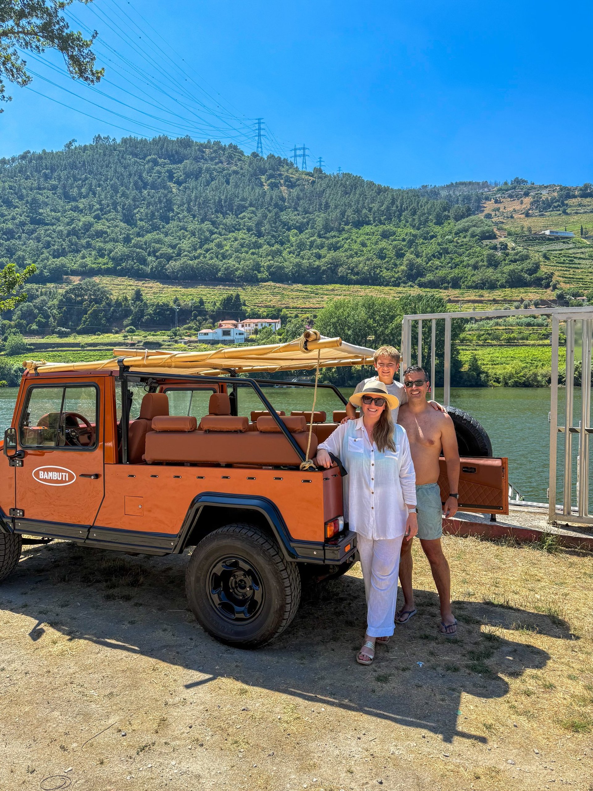a large body of water surrounded by a lush green hillside