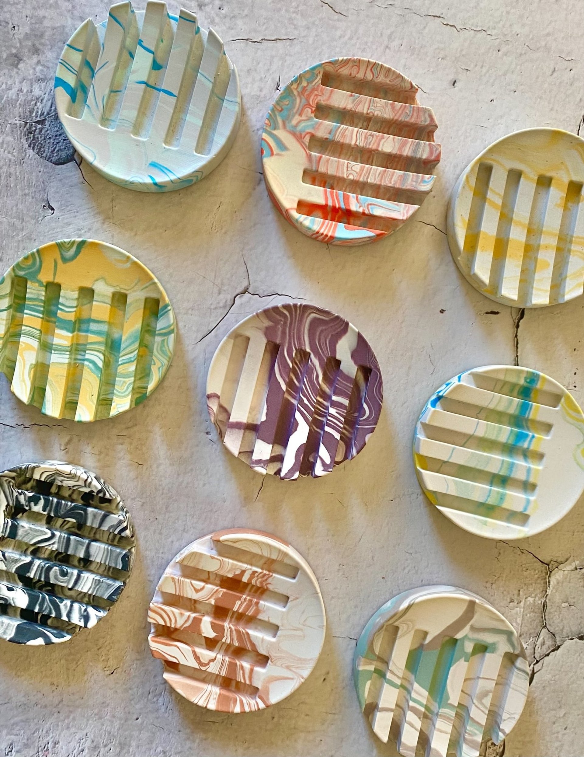 round jesmonite soap dishes in variety of colours and marbling effect