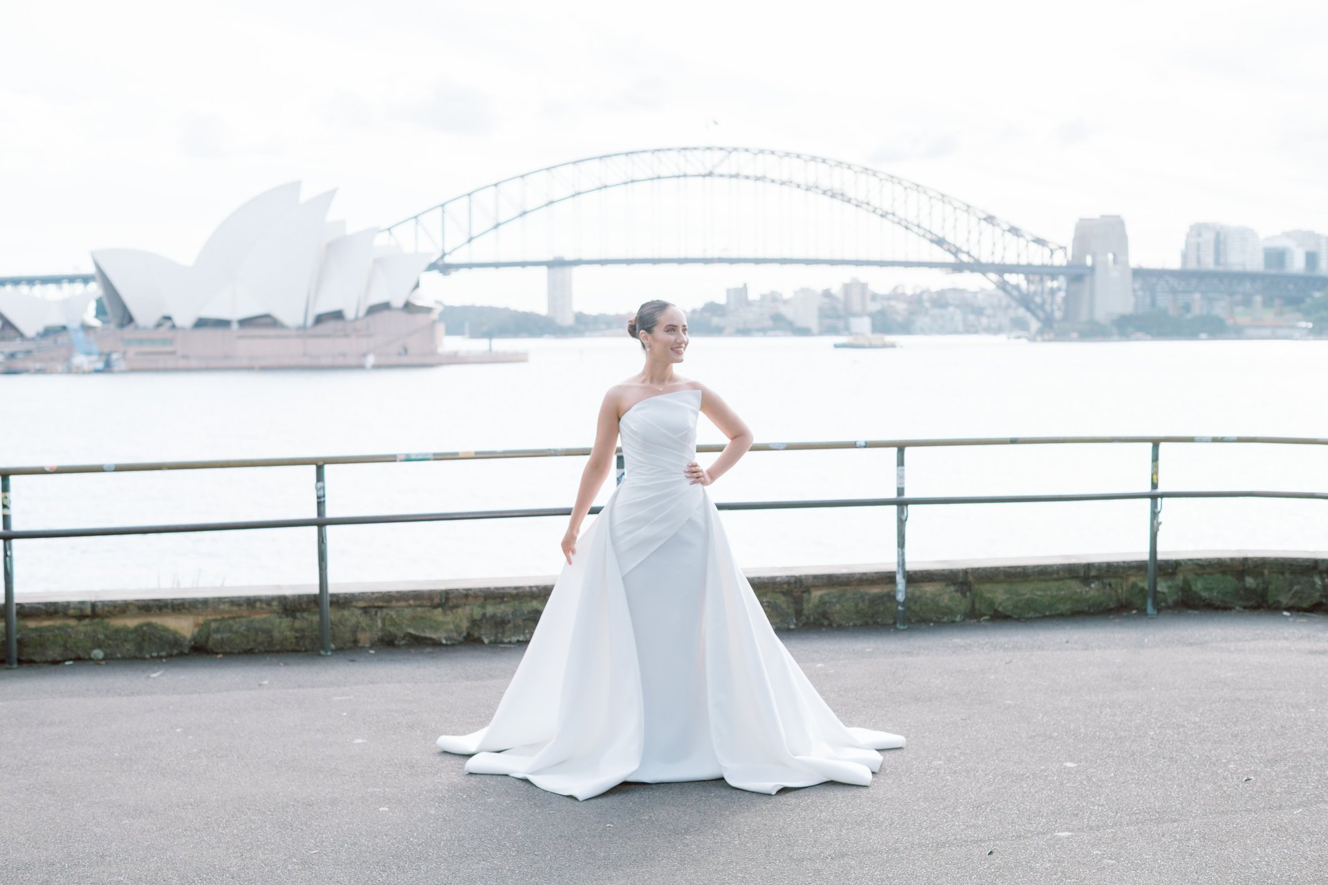 photo of woman wearing white gown near window curtain