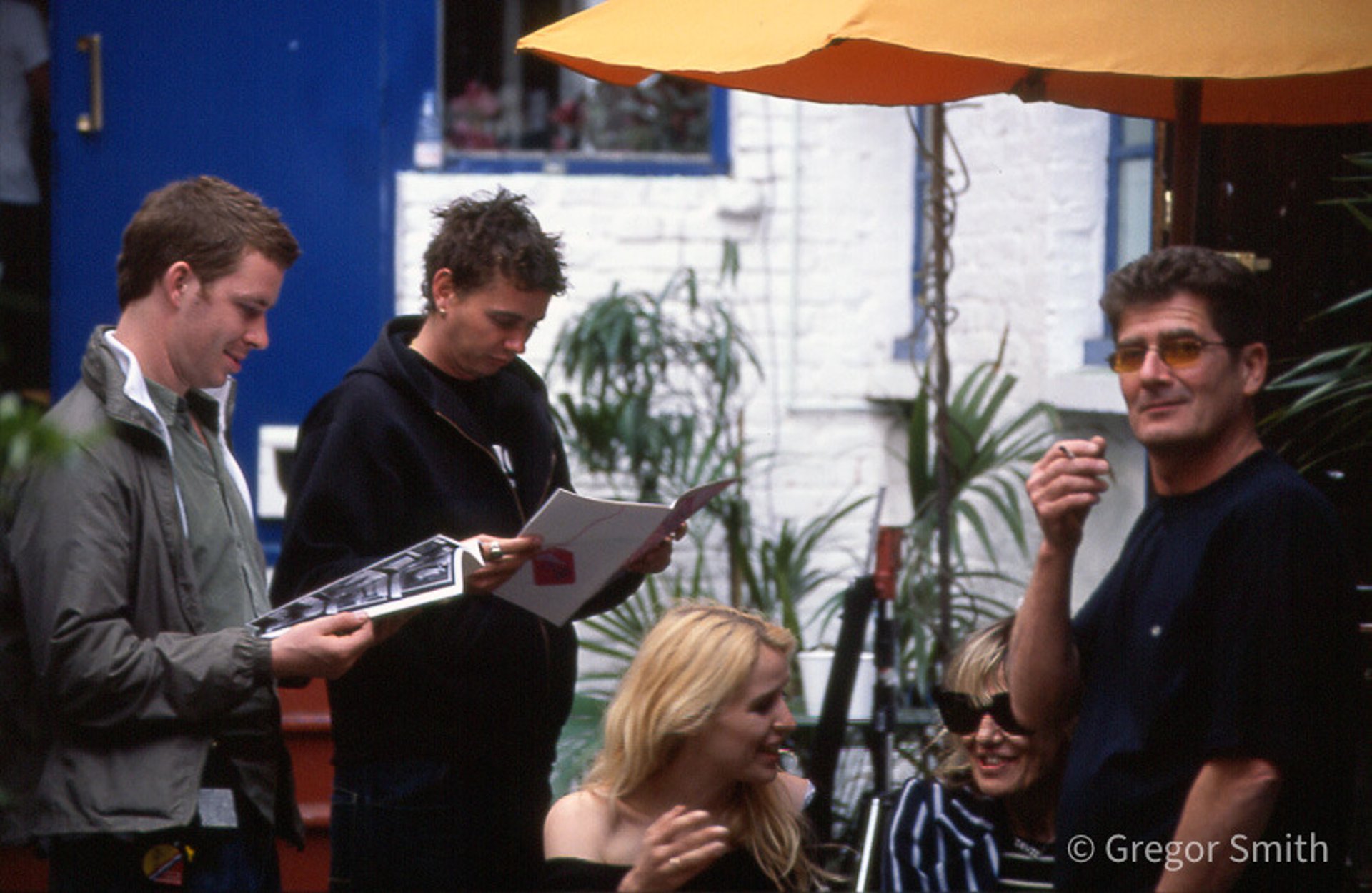 woman wearing yellow long-sleeved dress under white clouds and blue sky during daytime