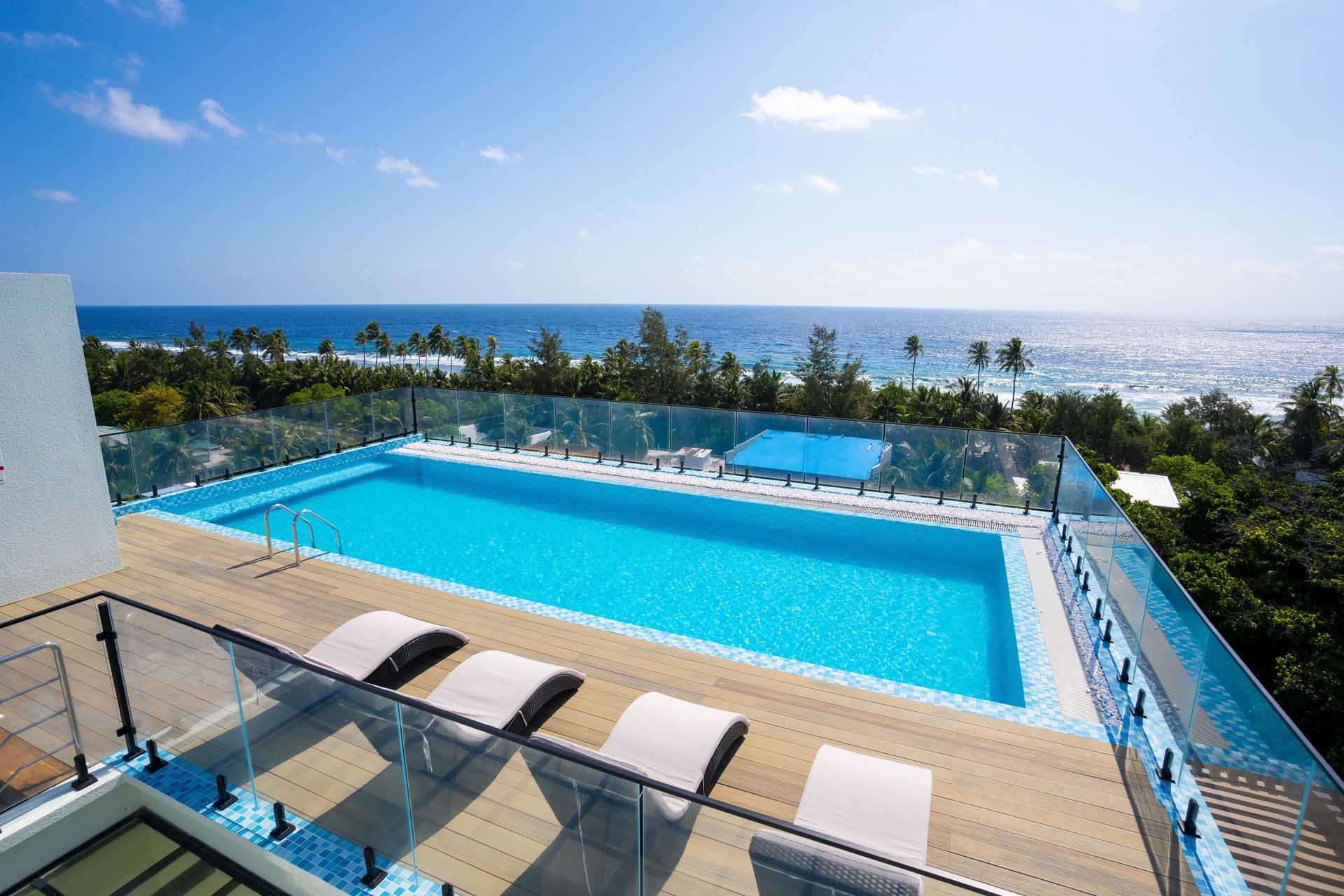 a row of houses sitting on top of a pier next to the ocean