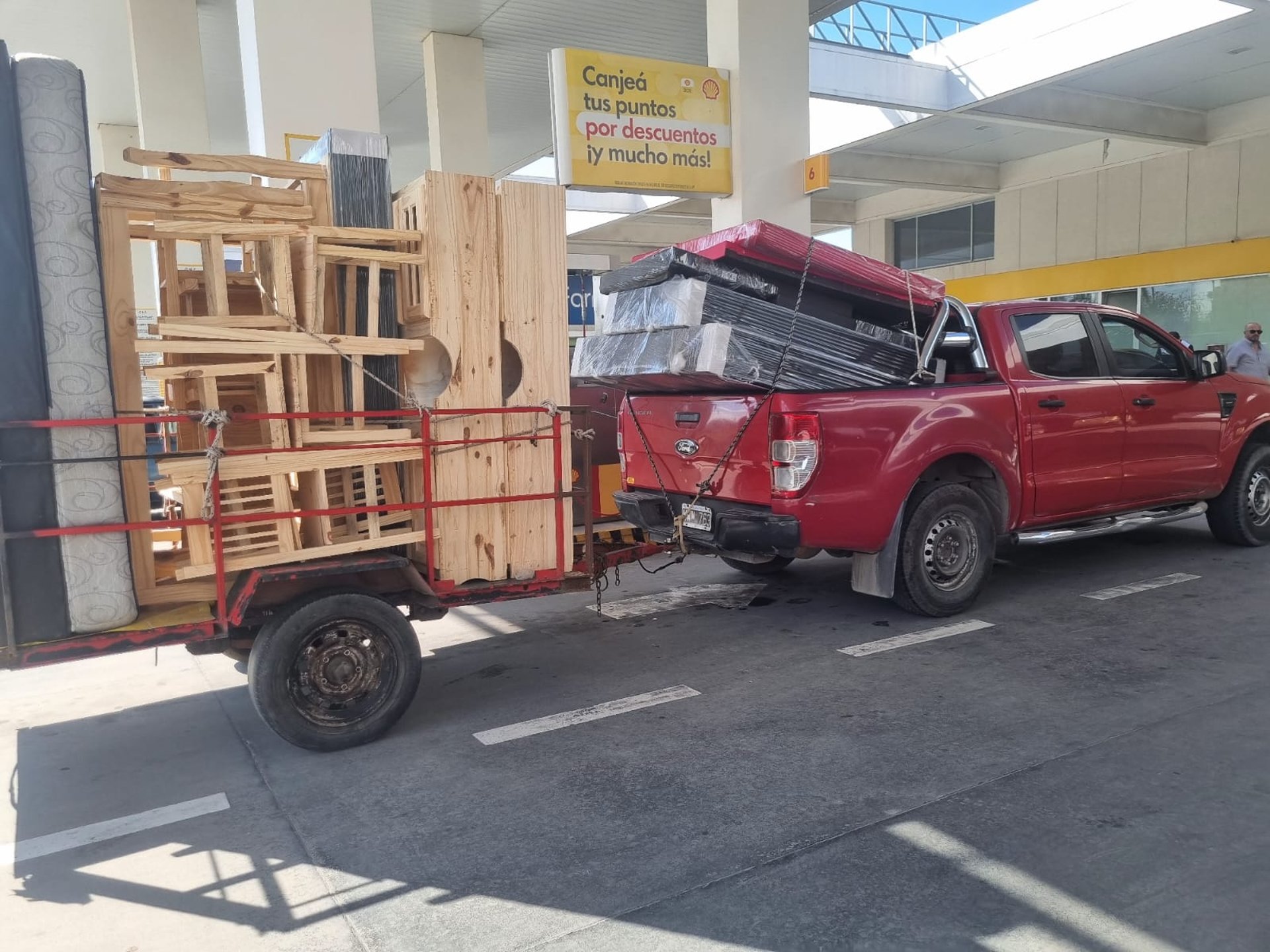 2 boys in red shirt sitting on yellow metal bar