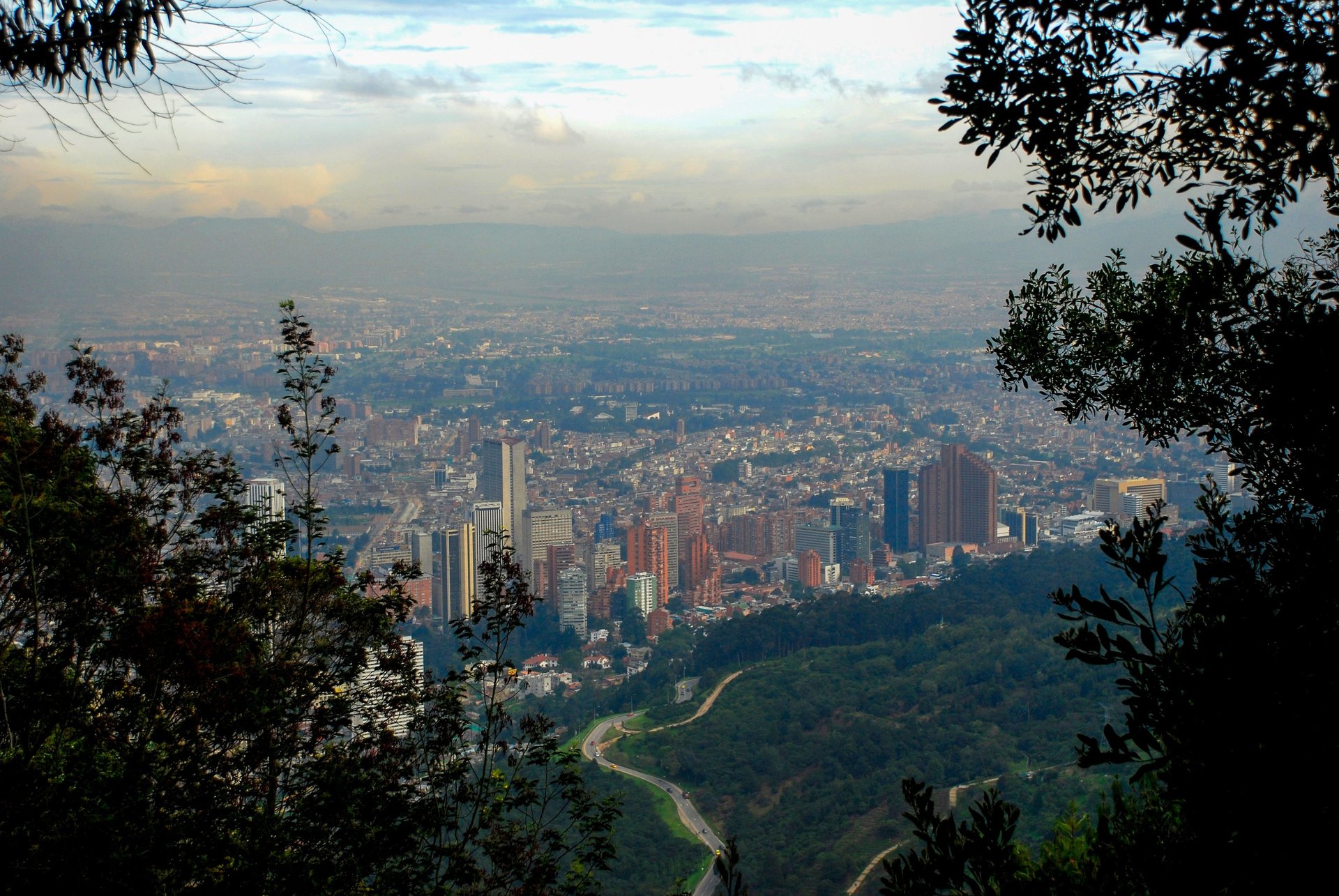 an airplane flying in front of a very tall building