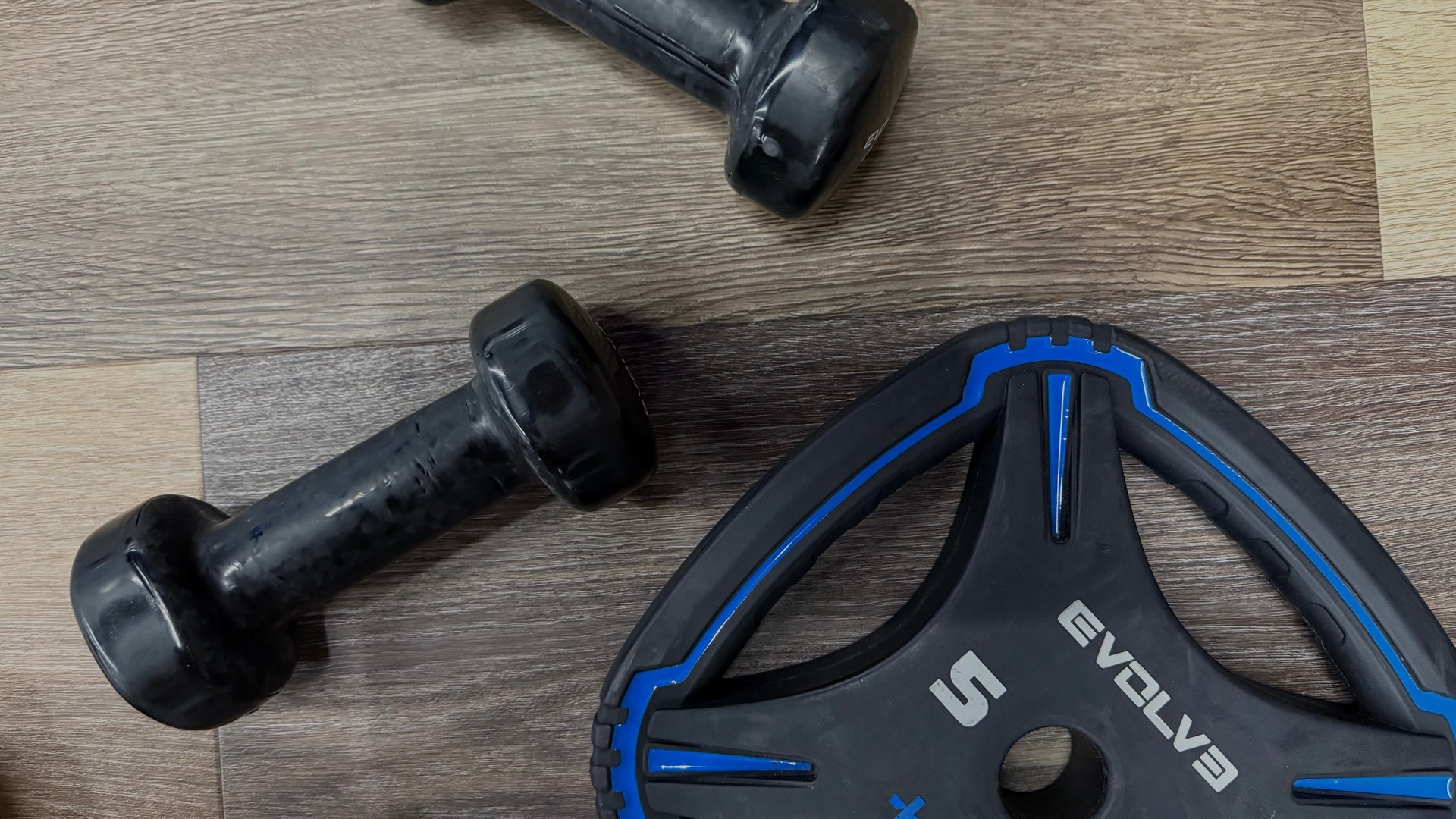 woman in black tank top and black pants bending her body on floor
