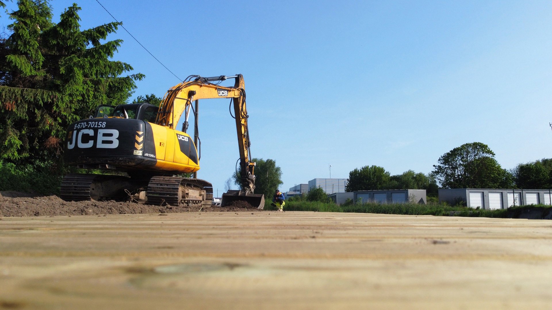 yellow and black excavator on brown sand during daytime