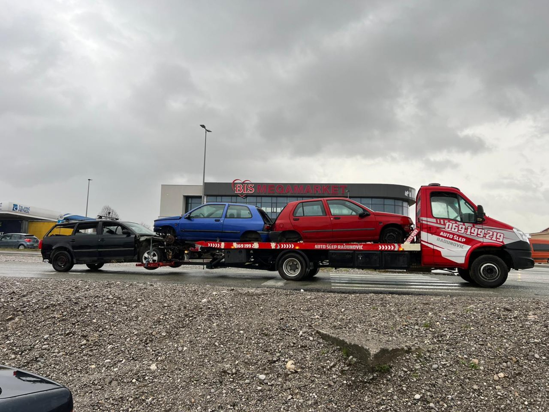 white and black coupe on trailer during daytime