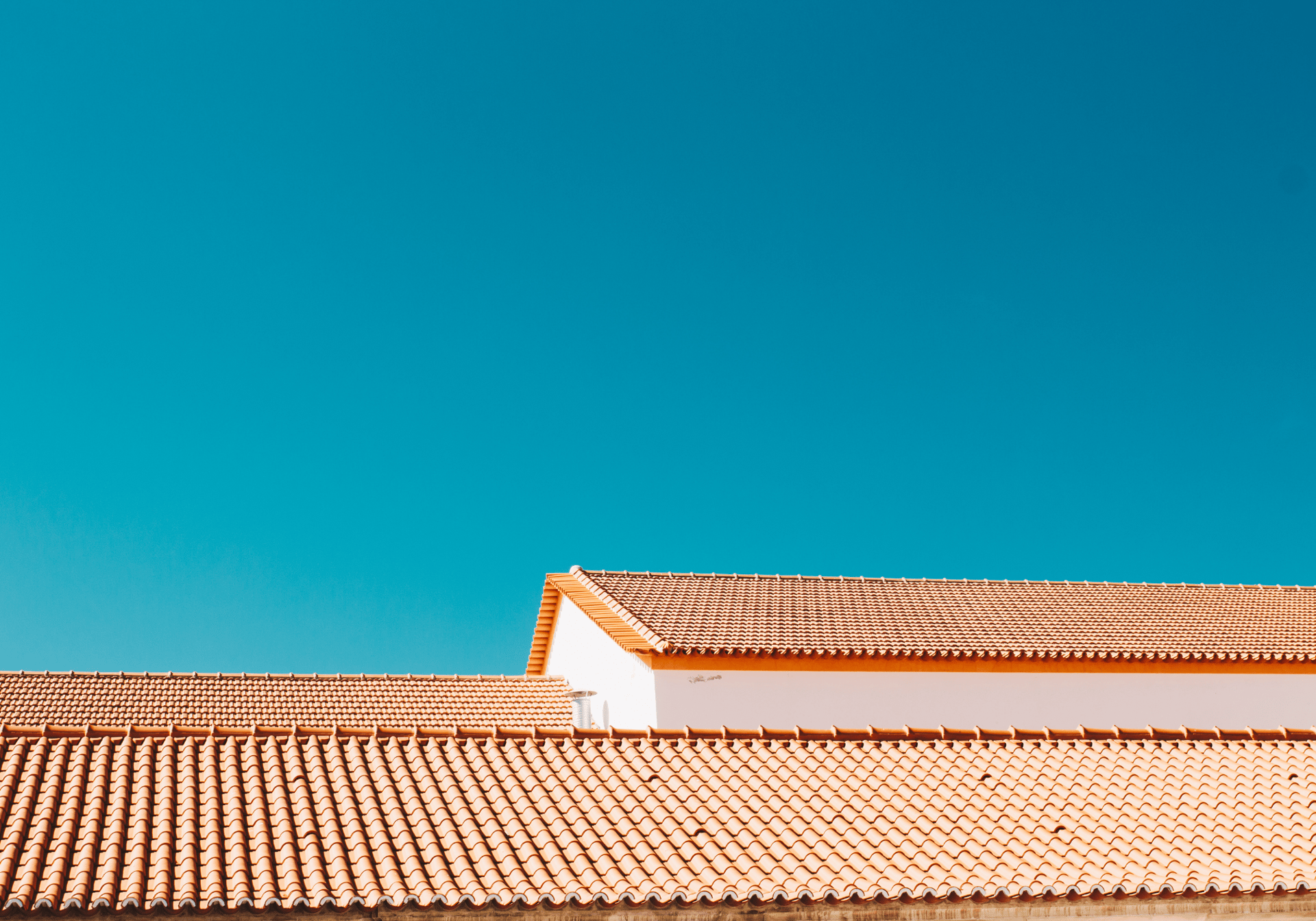 an abstract photo of a curved building with a blue sky in the background