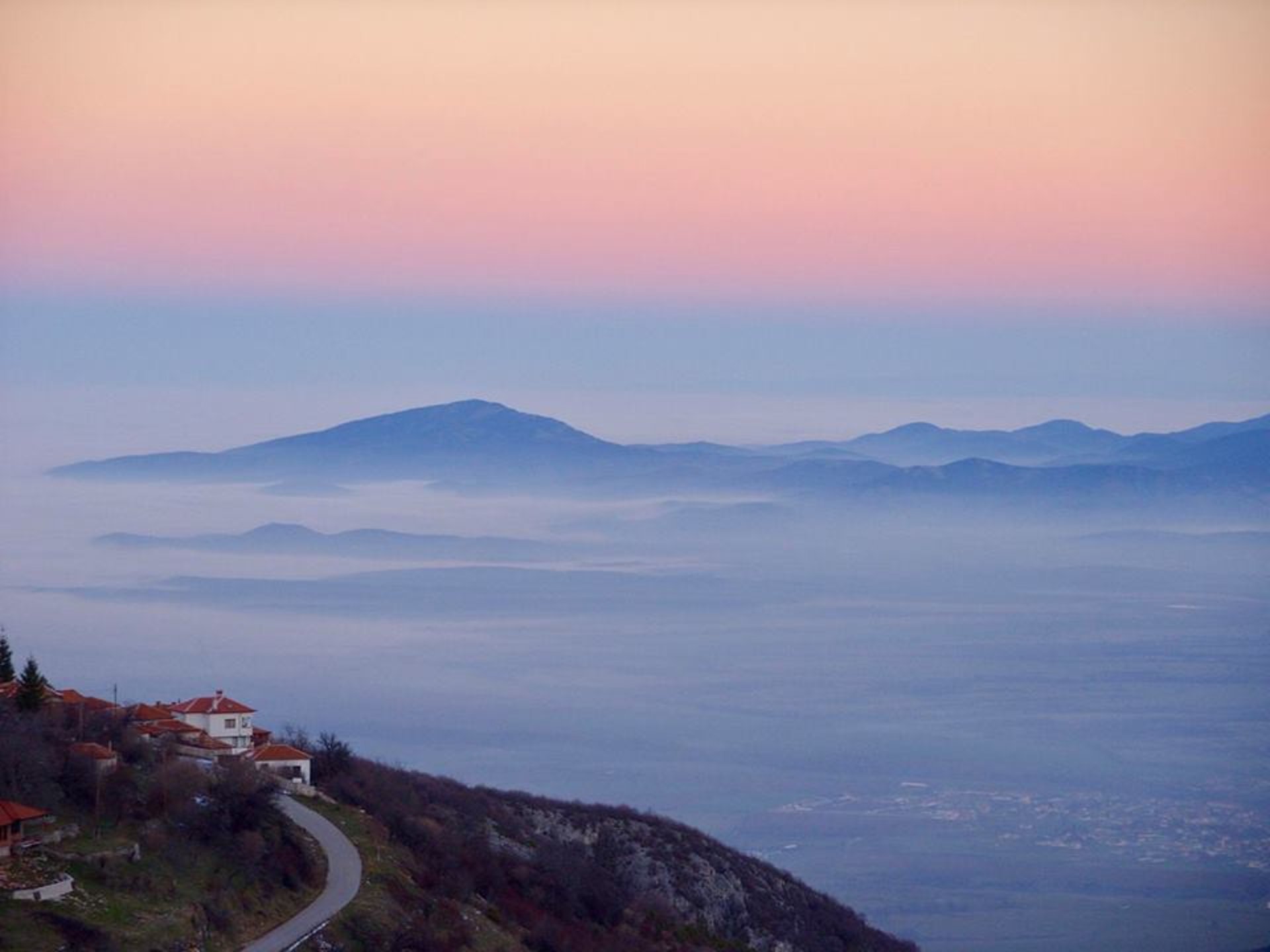 an abstract photo of a curved building with a blue sky in the background