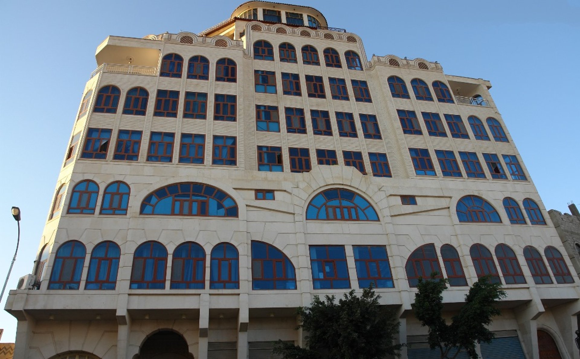 an abstract photo of a curved building with a blue sky in the background