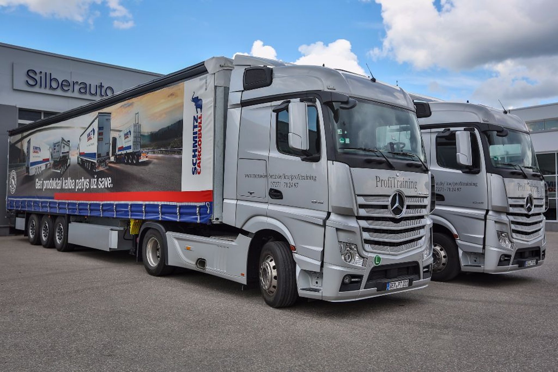 man in black suit driving car during daytime