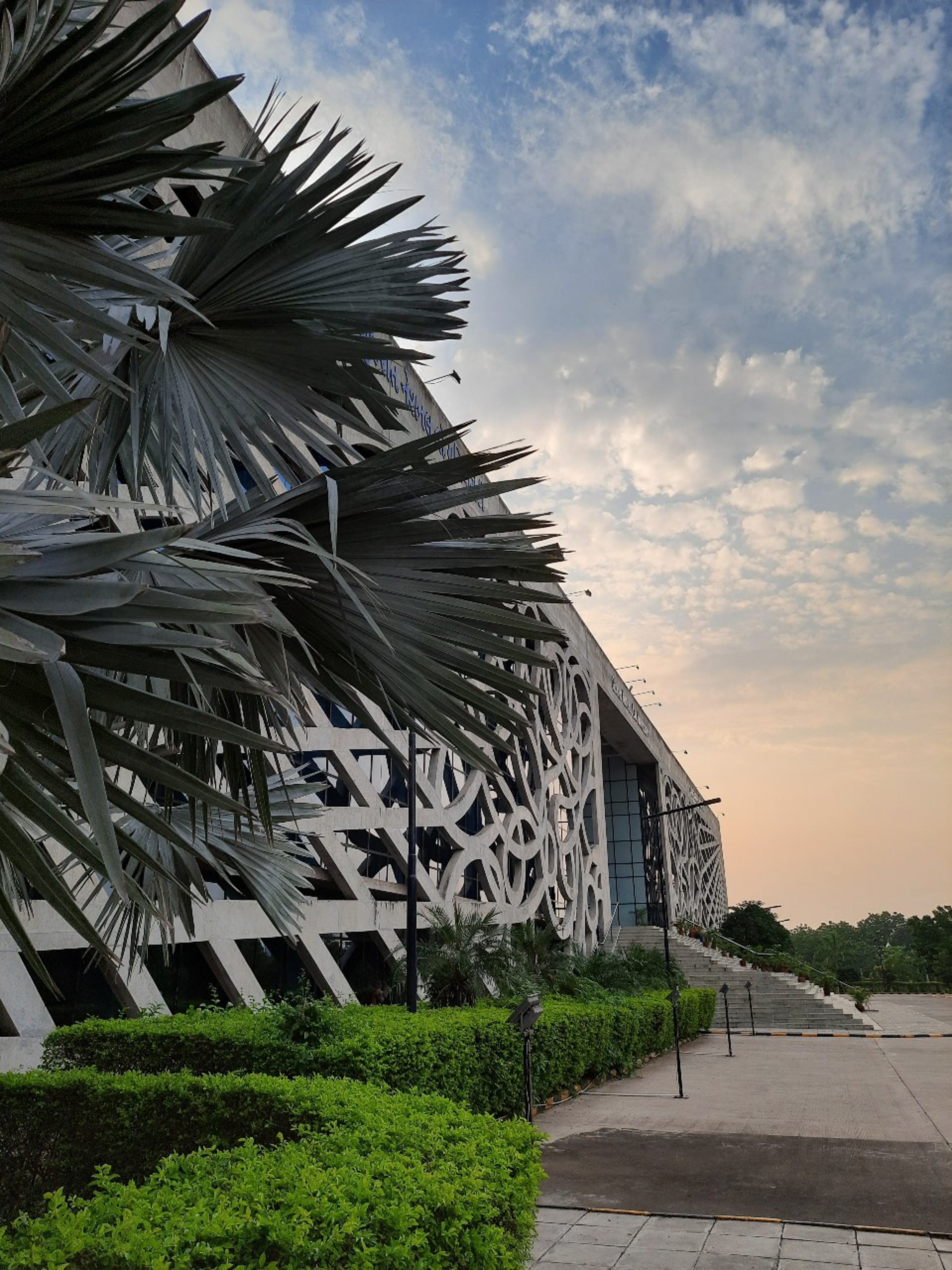 an abstract photo of a curved building with a blue sky in the background