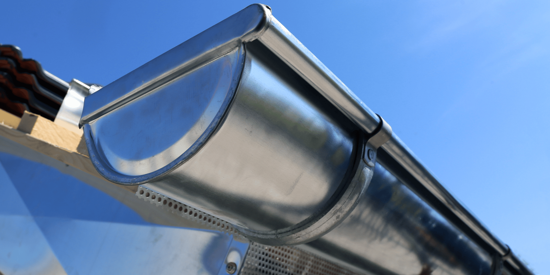 an abstract photo of a curved building with a blue sky in the background