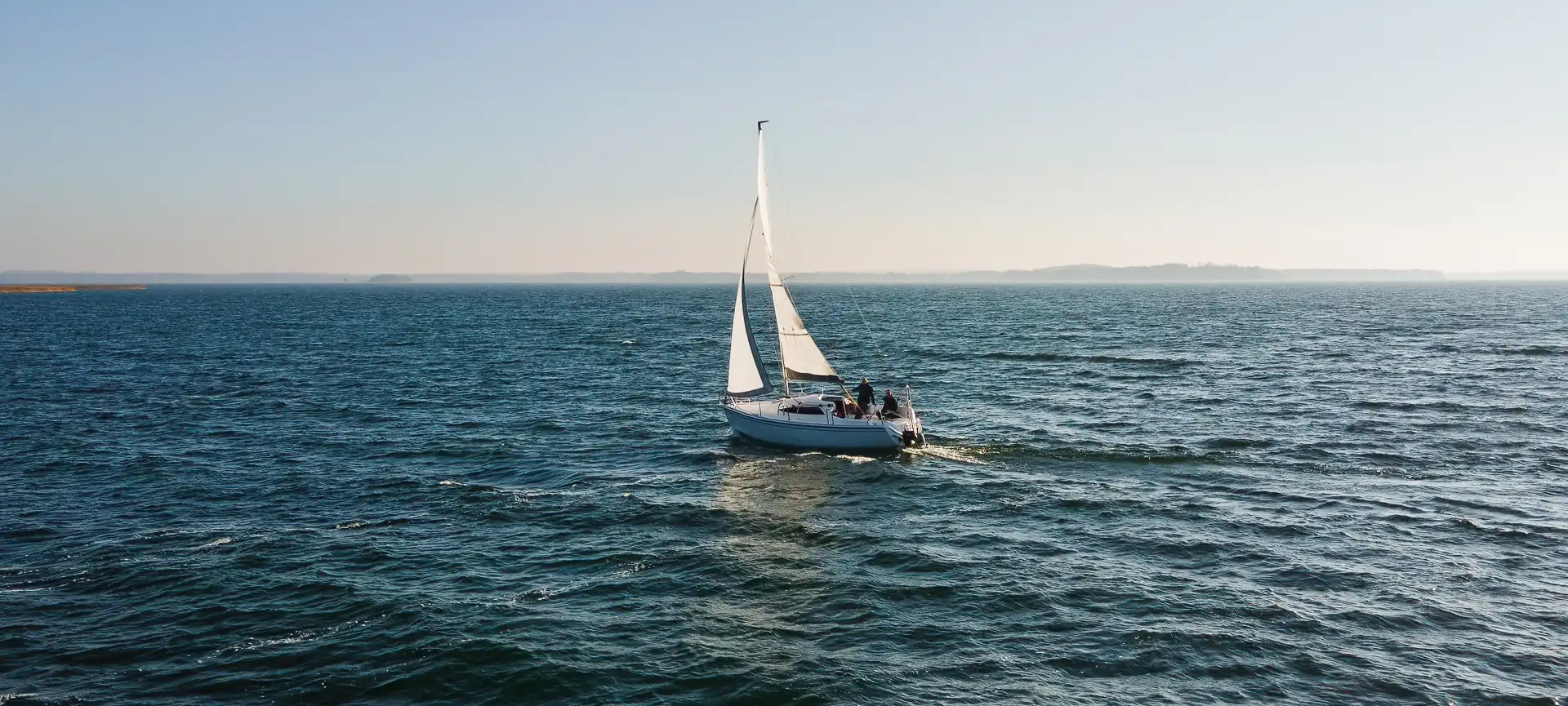 an abstract photo of a curved building with a blue sky in the background