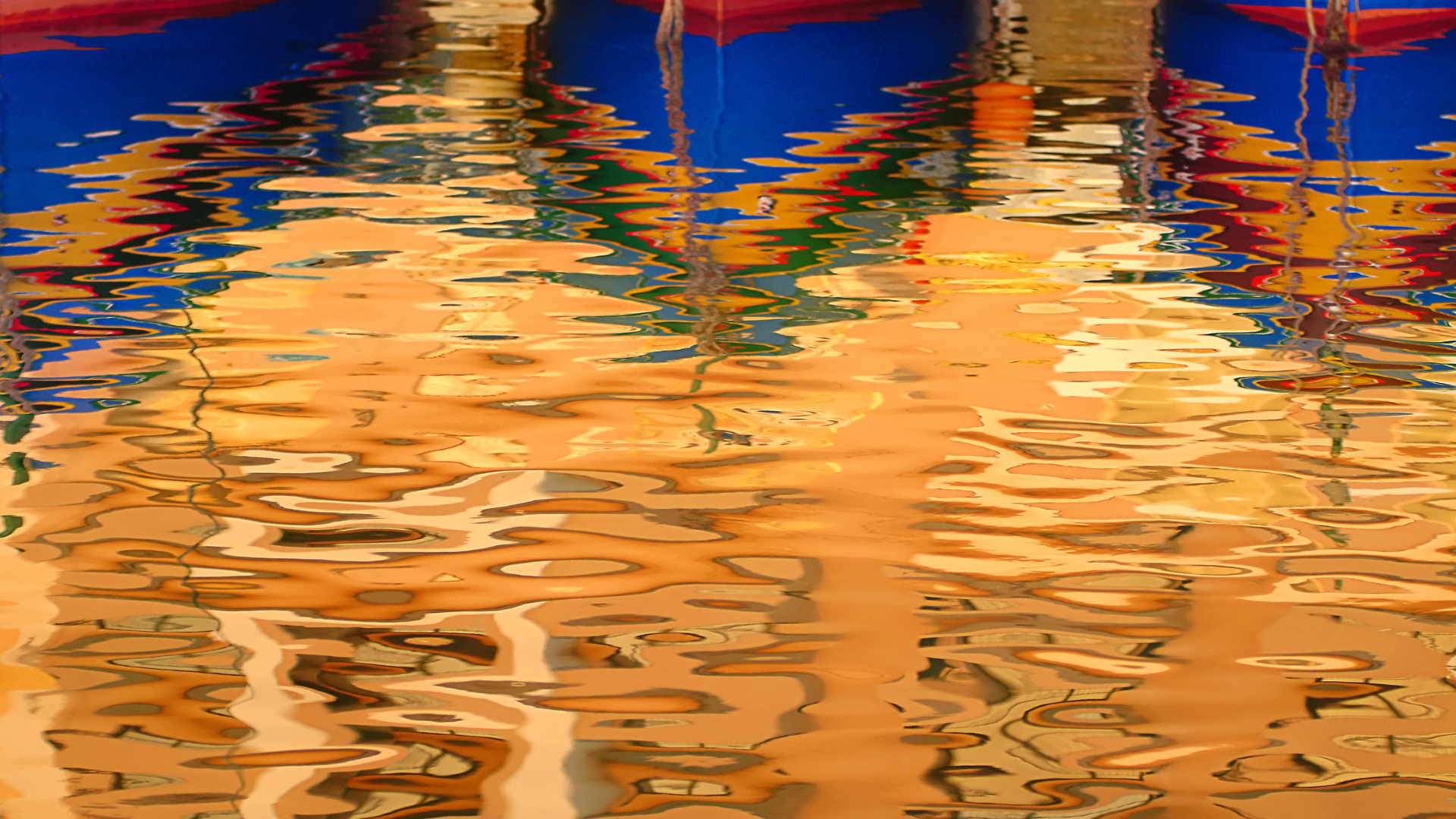 Reflection of three luzzus in water. 