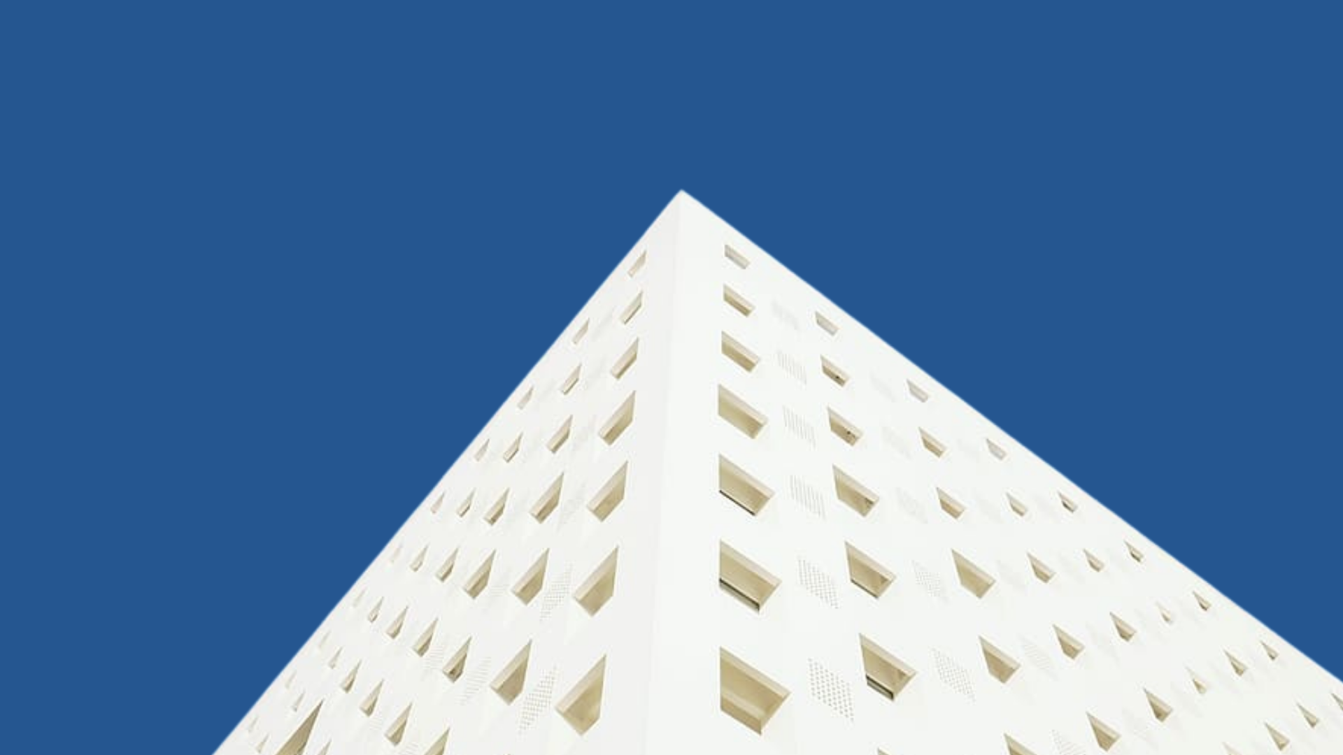 worm's eye view photography of white building under blue clear sky during daytime