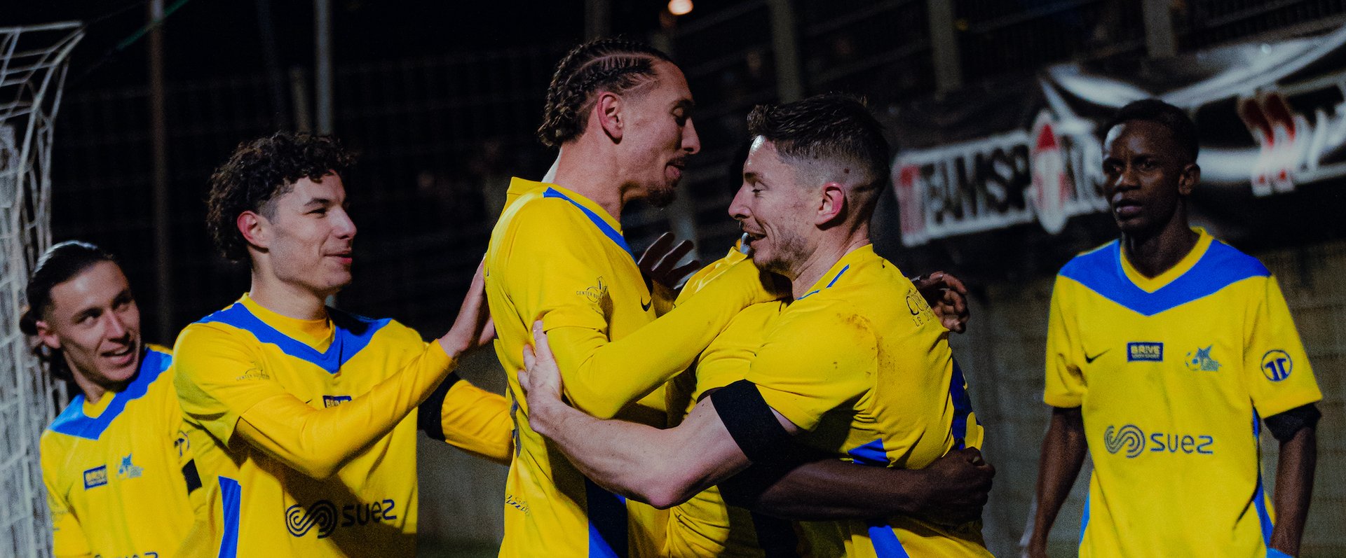 an abstract photo of a curved building with a blue sky in the background
