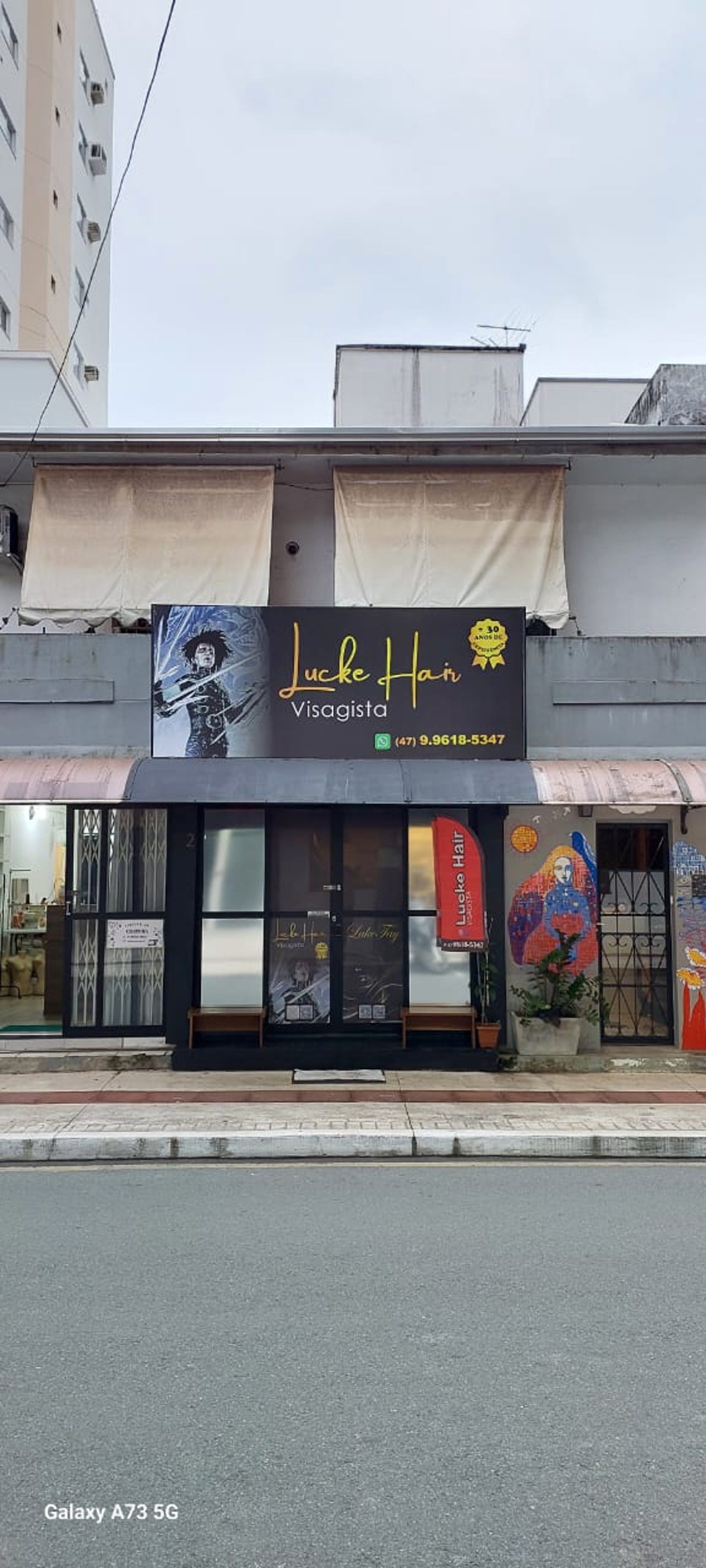 man and woman standing in front of brown concrete building during daytime