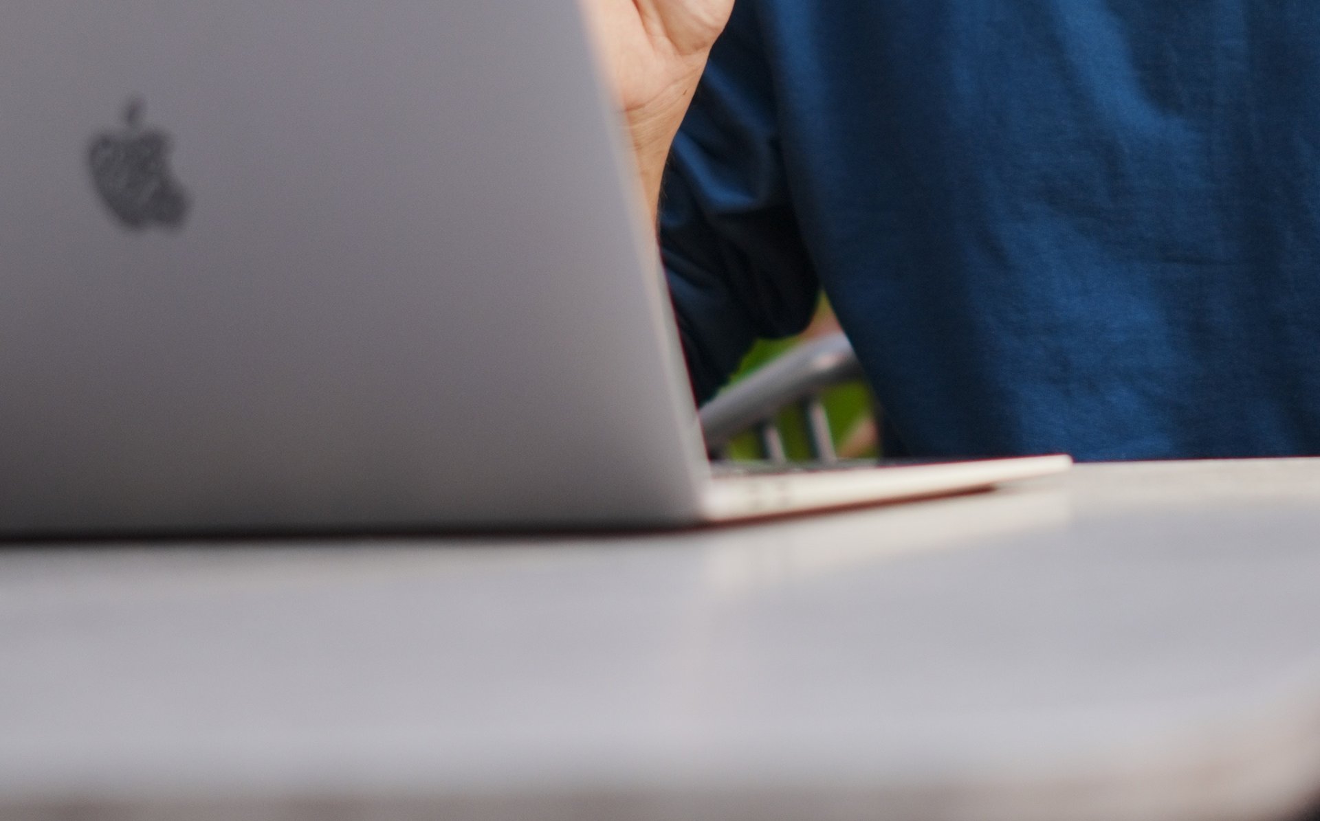 man sits in front of laptop