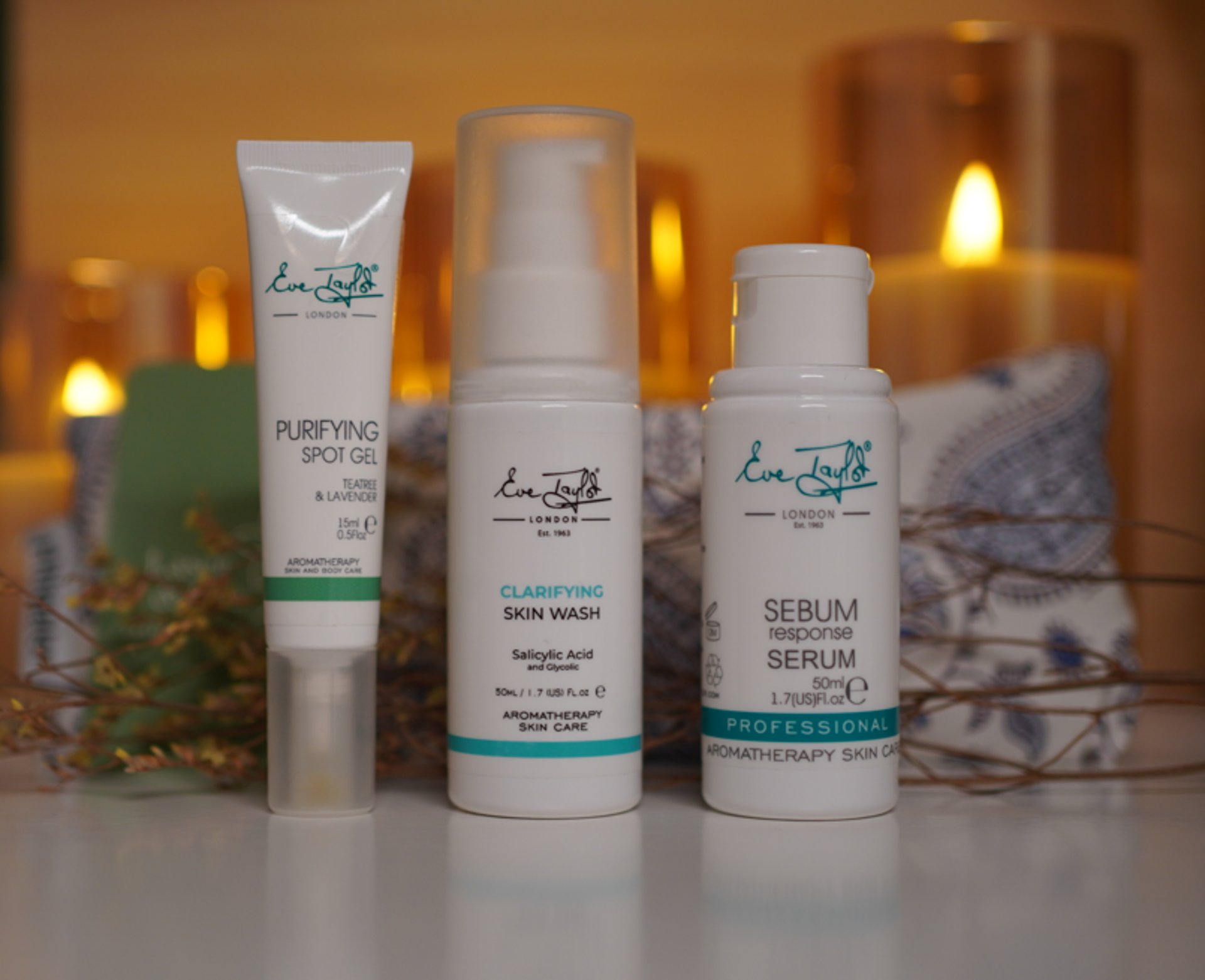 a woman laying on top of a bed holding a hair dryer