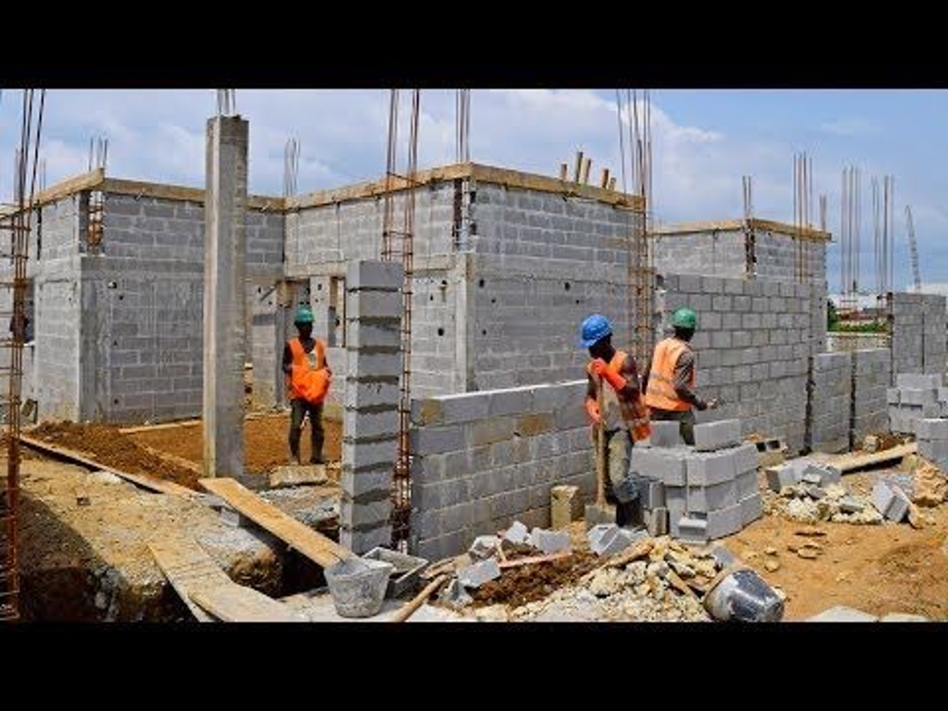 an abstract photo of a curved building with a blue sky in the background